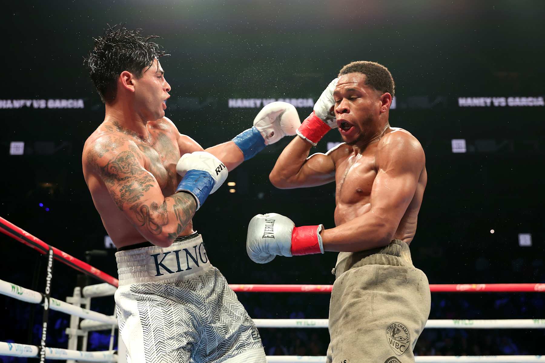 NEW YORK, NEW YORK - APRIL 20: Ryan Garcia (white trunks) punches Devin Haney (gray trunks) during their WBC Super Lightweight title bout at Barclays Center on April 20, 2024 in New York City.  (Photo by Al Bello/Getty Images)