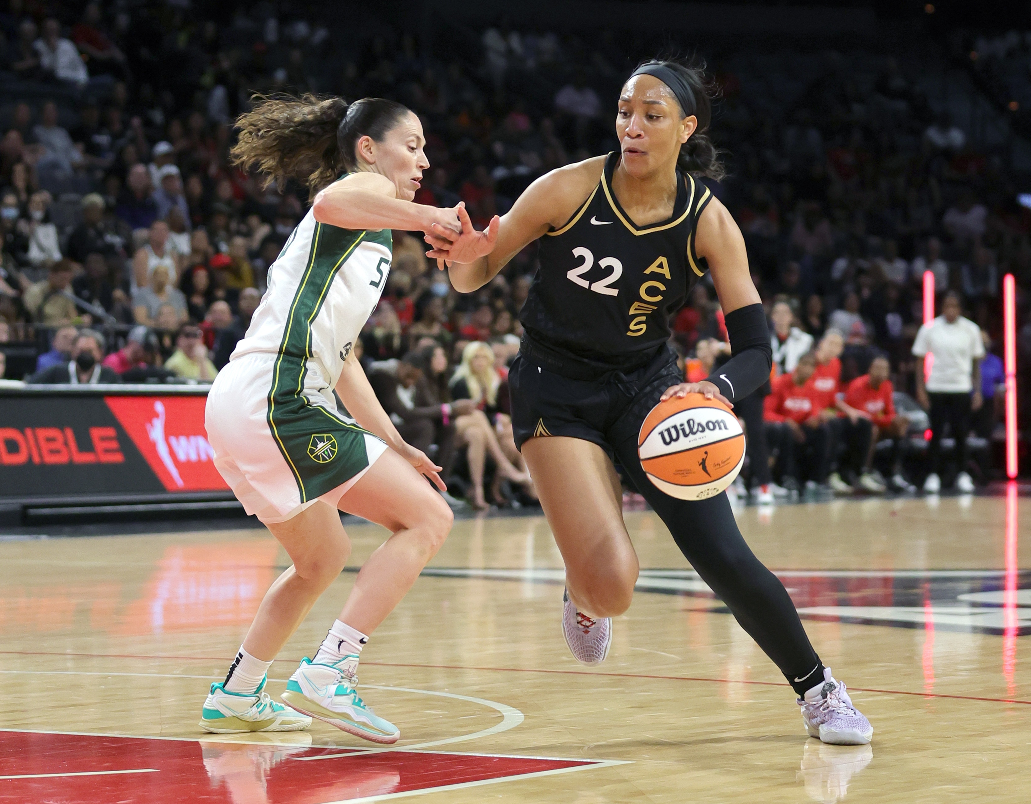 LAS VEGAS, NEVADA - MAY 08: A'ja Wilson #22 of the Las Vegas Aces drives against Sue Bird #10 of the Seattle Storm during their game at Michelob ULTRA Arena on May 08, 2022 in Las Vegas, Nevada. The Aces defeated the Storm 85-74. NOTE TO USER: User expressly acknowledges and agrees that, by downloading and or using this photograph, User is consenting to the terms and conditions of the Getty Images License Agreement. (Photo by Ethan Miller/Getty Images)
