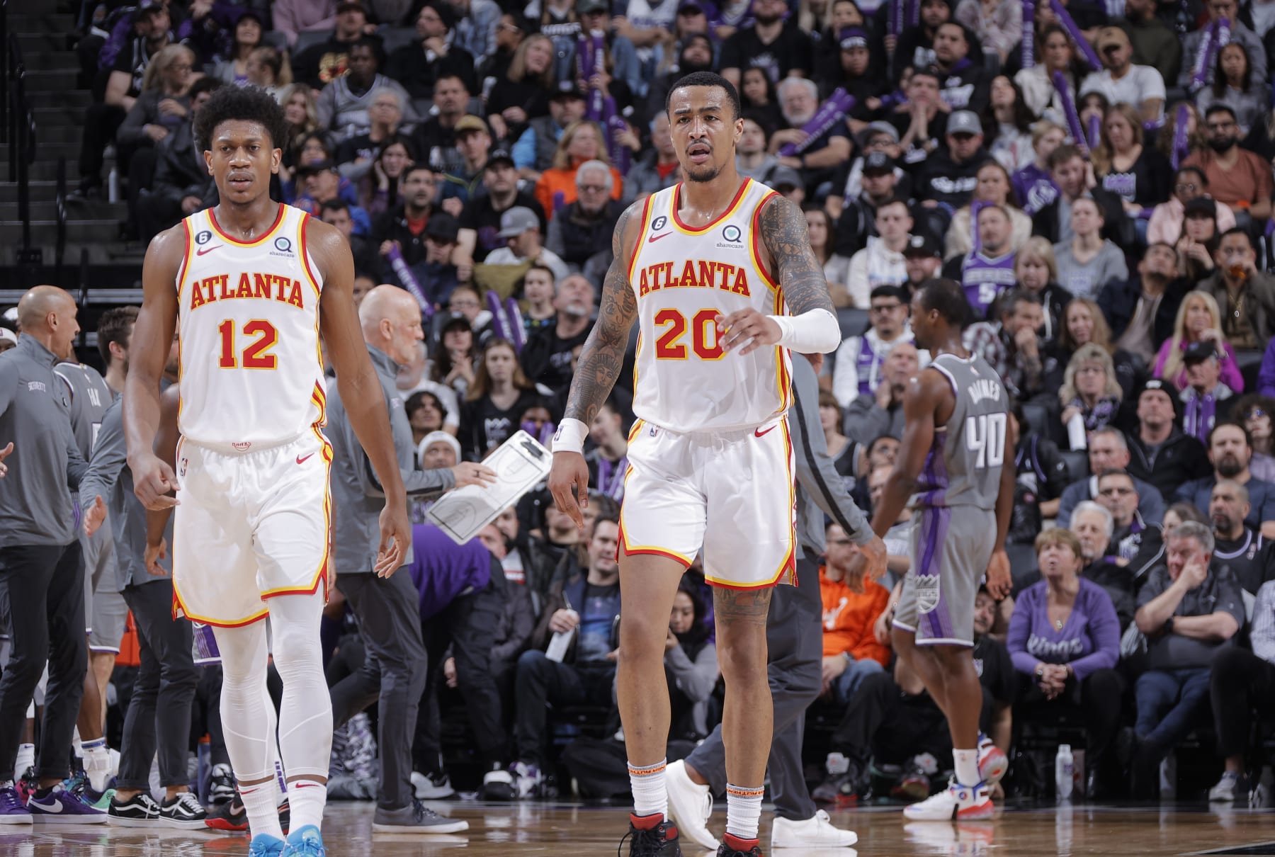SACRAMENTO, CA - JANUARY 4: John Collins #20 and DeAndre Hunter #12 of the Atlanta Hawks looks on during the game against the Sacramento Kings on January 4, 2023 at Golden 1 Center in Sacramento, California. NOTE TO USER: User expressly acknowledges and agrees that, by downloading and or using this photograph, User is consenting to the terms and conditions of the Getty Images Agreement. Mandatory Copyright Notice: Copyright 2023 NBAE (Photo by Rocky Widner/NBAE via Getty Images)
