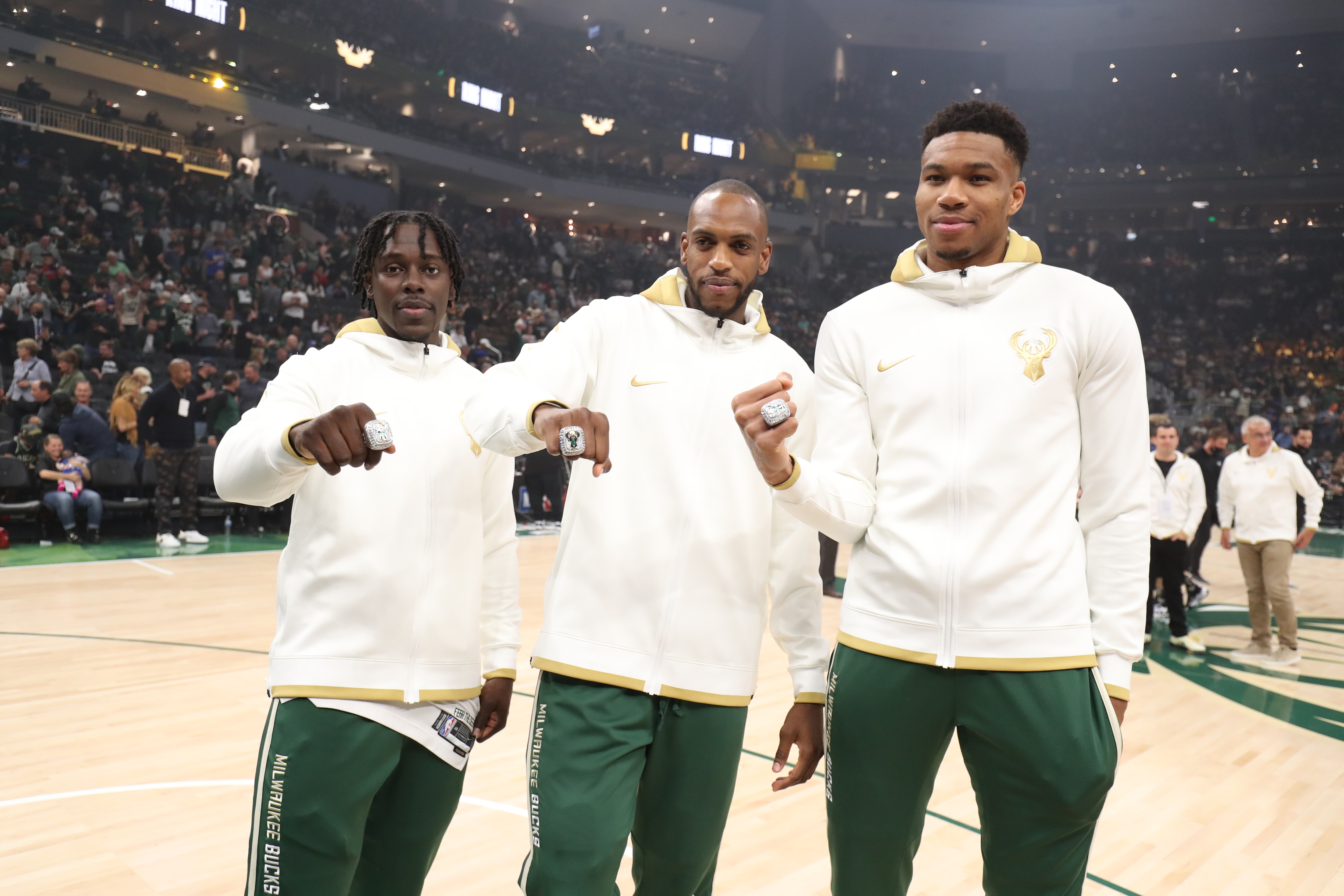 MILWAUKEE, WI - OCTOBER 19: Jrue Holiday #21, Khris Middleton #22, and Giannis Antetokounmpo #34 of the Milwaukee Bucks receive the 2021 NBA Championship ring before the game against the Brooklyn Nets on October 19, 2021 at the Fiserv Forum Center in Milwaukee, Wisconsin. NOTE TO USER: User expressly acknowledges and agrees that, by downloading and or using this Photograph, user is consenting to the terms and conditions of the Getty Images License Agreement. Mandatory Copyright Notice: Copyright 2021 NBAE (Photo by Nathaniel S. Butler/NBAE via Getty Images).