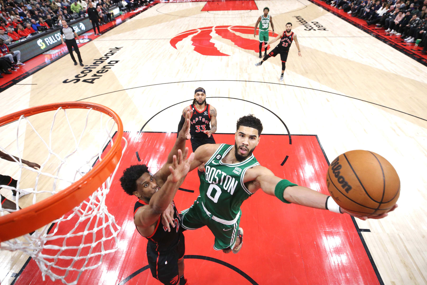 TORONTO, ON - DECEMBER 05: Jayson Tatum #0 of the Boston Celtics drives to the net against Thaddeus Young #21 of the Toronto Raptors in the second half of their NBA game at Scotiabank Arena on December 5, 2022 in Toronto, Canada. NOTE TO USER: User expressly acknowledges and agrees that, by downloading and or using this photograph, User is consenting to the terms and conditions of the Getty Images License Agreement. (Photo by Cole Burston/Getty Images)