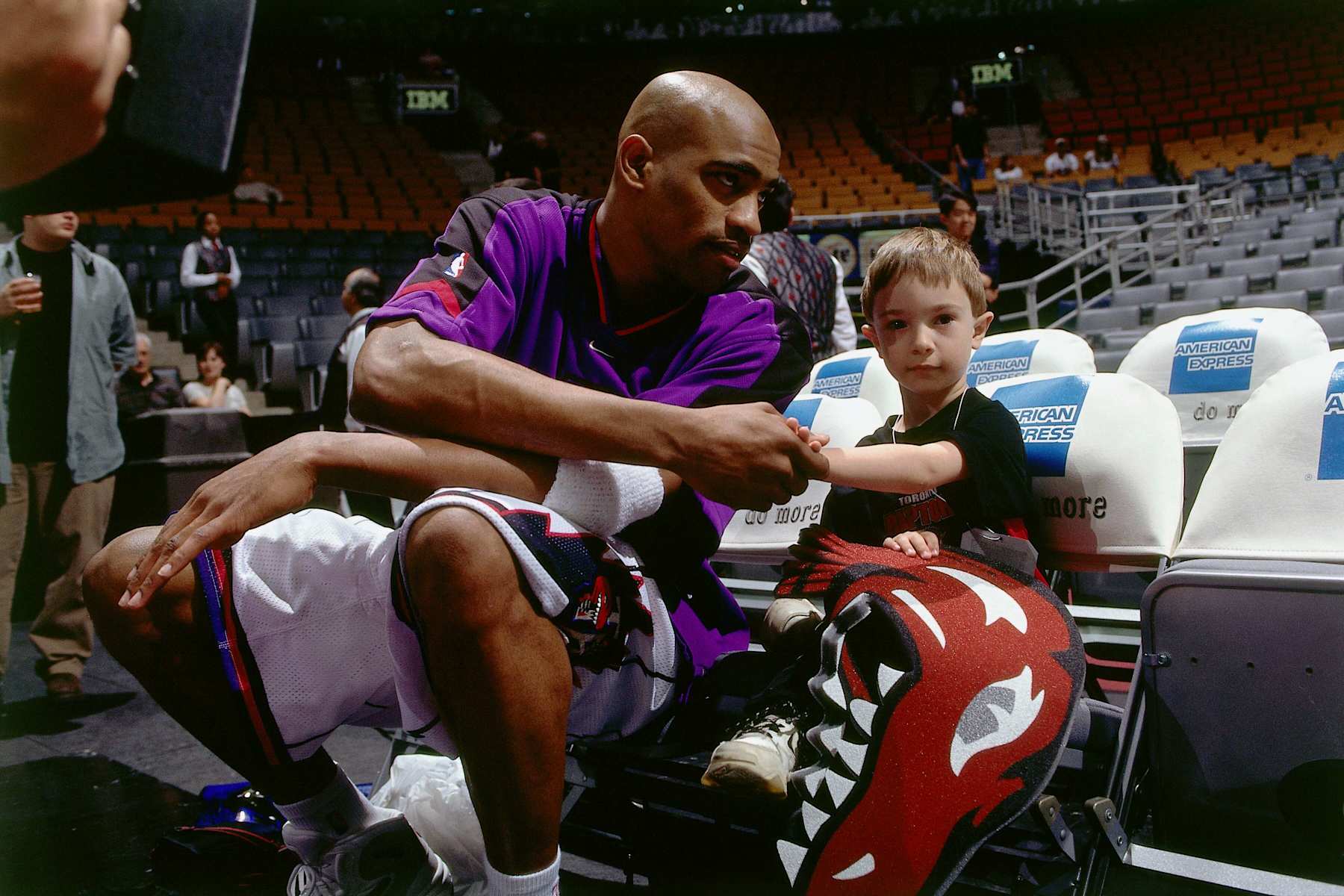 TORONTO - 1999:  Vince Carter #15 of the Toronto Raptors hangs out with a young fan at the Air Canada Centre prior to the NBA game circa 1999 in Toronto, Canada.  NOTE TO USER: User expressly acknowledges and agrees that, by downloading and or using this photograph, User is consenting to the terms and conditions of the Getty Images License Agreement. (Photo by Ron Turenne/NBAE via Getty Images)