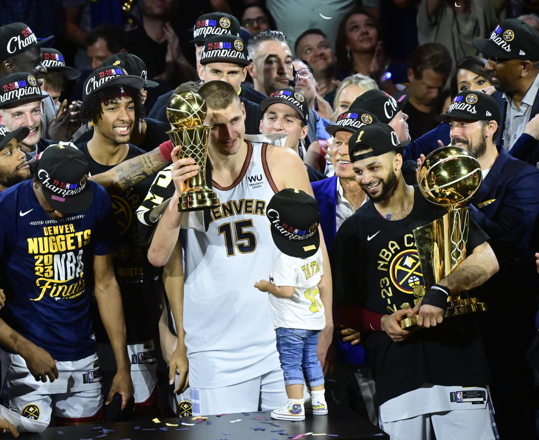DENVER, CO - JUNE 12: NBA Finals MVP Nikola Jokic (15) of the Denver Nuggets holds the MVP trophy acknowledging the fans with his daughter Ognjena and Jamal Murray next to him on stage after defeating the Miami Heat at Ball Arena June 12, 2023. (Photo by Andy Cross/MediaNews Group/The Denver Post via Getty Images)