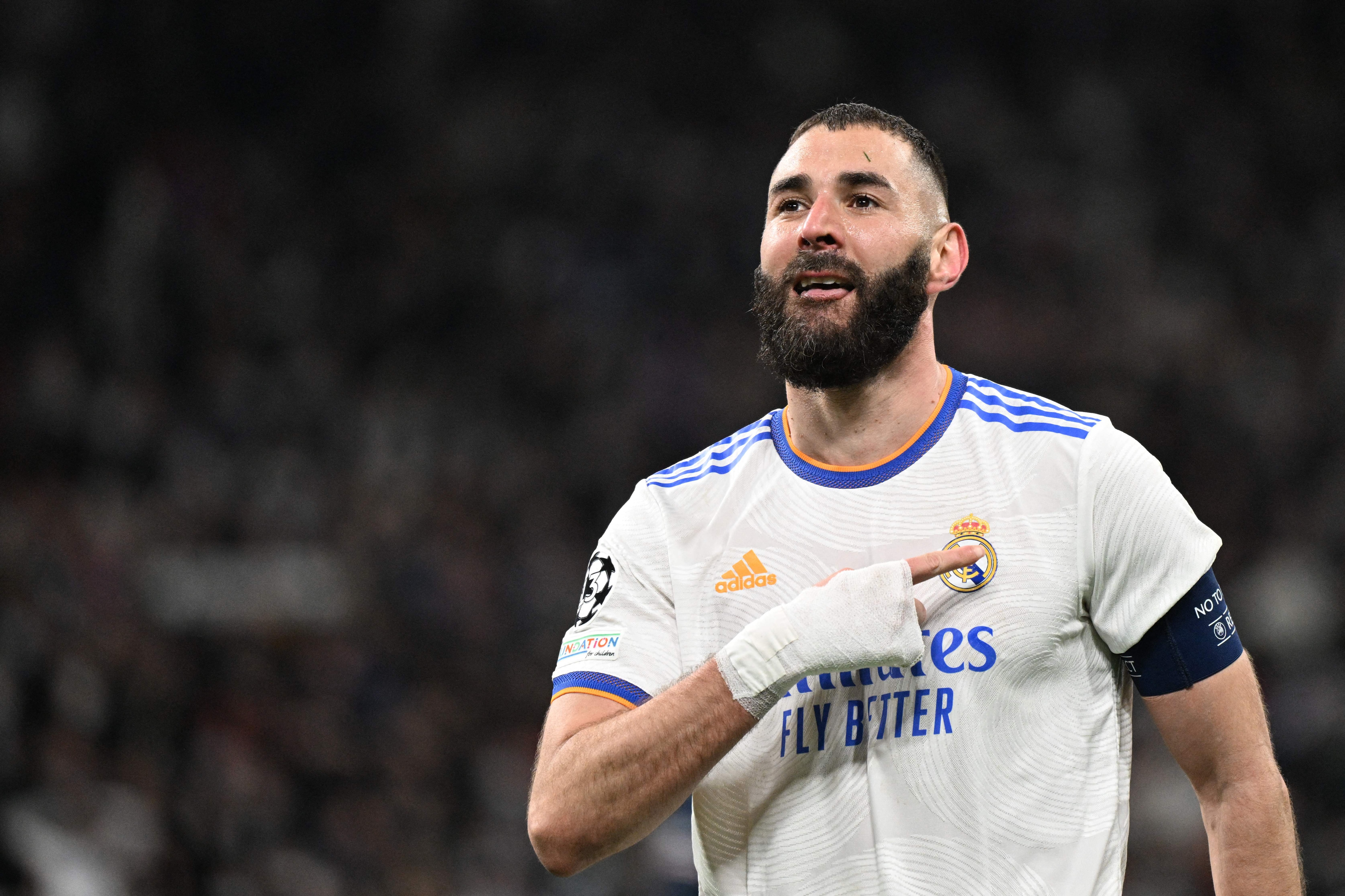 Real Madrid's French forward Karim Benzema celebrates after scoring a goal during the UEFA Champions League round of 16 second league football match between Real Madrid CF and Paris Saint-Germain at the Santiago Bernabeu stadium in Madrid on March 9, 2022. (Photo by GABRIEL BOUYS / AFP) (Photo by GABRIEL BOUYS/AFP via Getty Images)