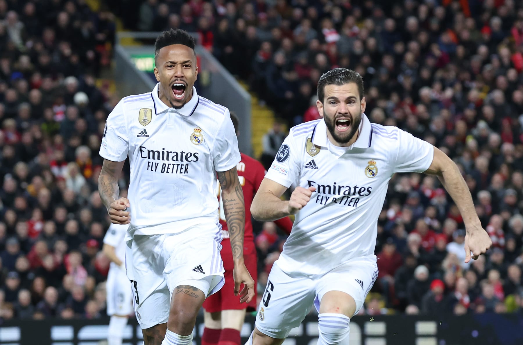 LIVERPOOL, ENGLAND - FEBRUARY 21: Eder Militao of Real Madrid celebrates after scoring the team's third goal with teammate Nacho Fernandez during the UEFA Champions League round of 16 leg one match between Liverpool FC and Real Madrid at Anfield on February 21, 2023 in Liverpool, England. (Photo by Alex Livesey - UEFA/UEFA via Getty Images)