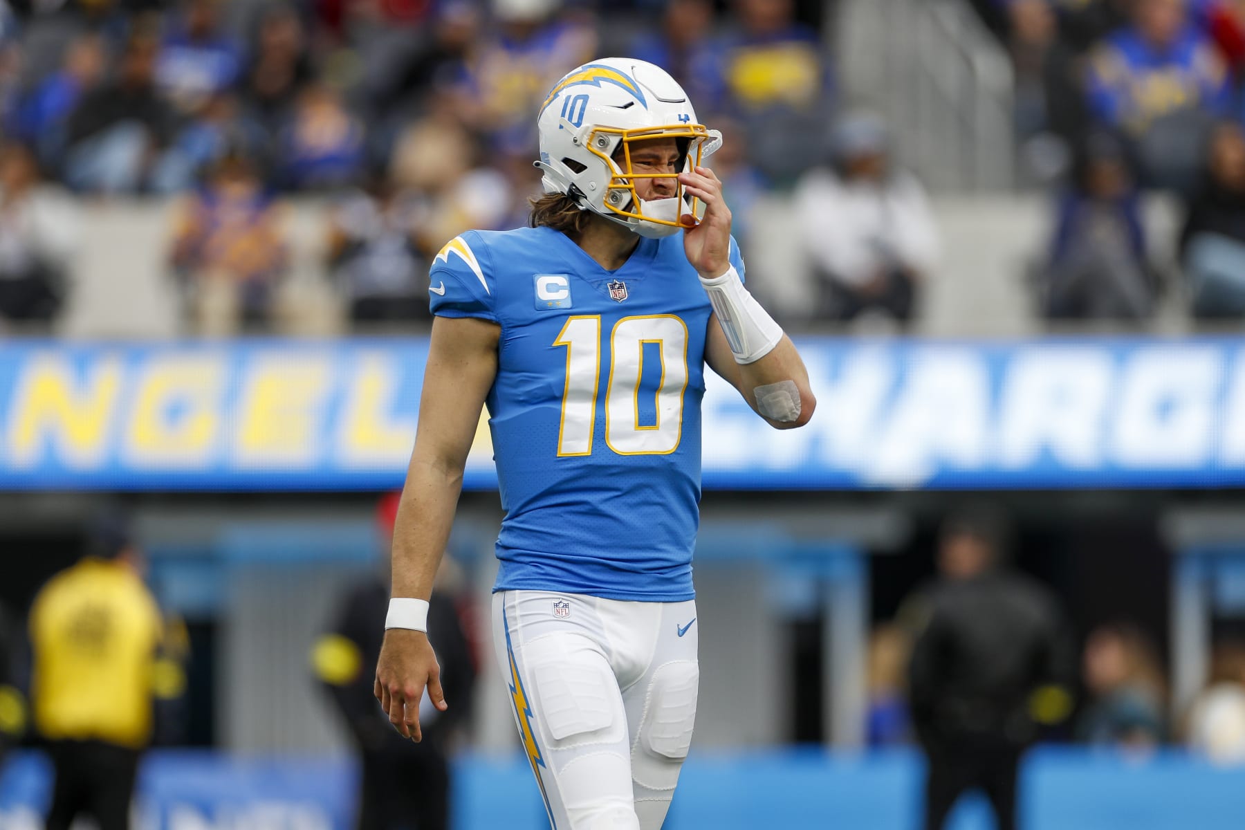 INGLEWOOD, CA - JANUARY 01: Los Angeles Chargers quarterback Justin Herbert (10) adjusts his helmet during an NFL regular season game between the Los Angeles Rams and the Los Angeles Chargers on January 01, 2023, at SoFi Stadium in Inglewood, CA. (Photo by Brandon Sloter/Icon Sportswire via Getty Images)