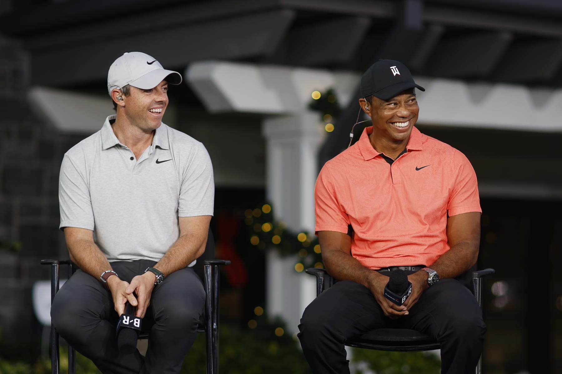 BELLEAIR, FLORIDA - DECEMBER 10:  (L-R) Rory McIlroy of Northern Ireland and Tiger Woods of the United States take part in the Bleacher Report Press Conference on the range prior to The Match 7 at Pelican Golf Club on December 10, 2022 in Belleair, Florida. (Photo by Mike Ehrmann/Getty Images for The Match)