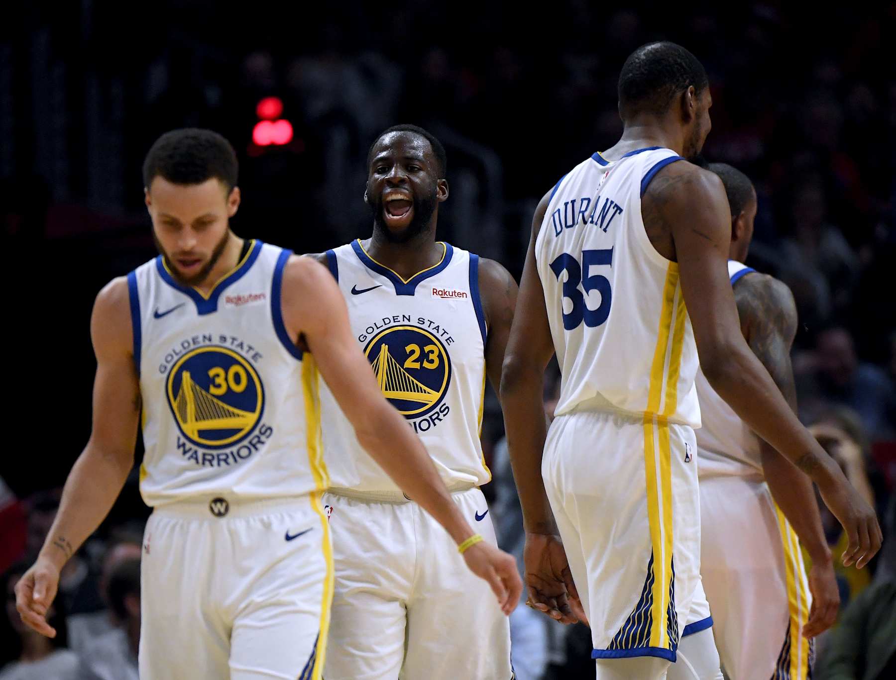 LOS ANGELES, CALIFORNIA - APRIL 26:   Draymond Green #23 of the Golden State Warriors reacts to Stephen Curry #30 and Kevin Durant #35 in a 129-110 win over the LA Clippers during Game Six of Round One of the 2019 NBA Playoffs at Staples Center on April 26, 2019 in Los Angeles, California. (Photo by Harry How/Getty Images)  NOTE TO USER: User expressly acknowledges and agrees that, by downloading and or using this photograph, User is consenting to the terms and conditions of the Getty Images License Agreement.