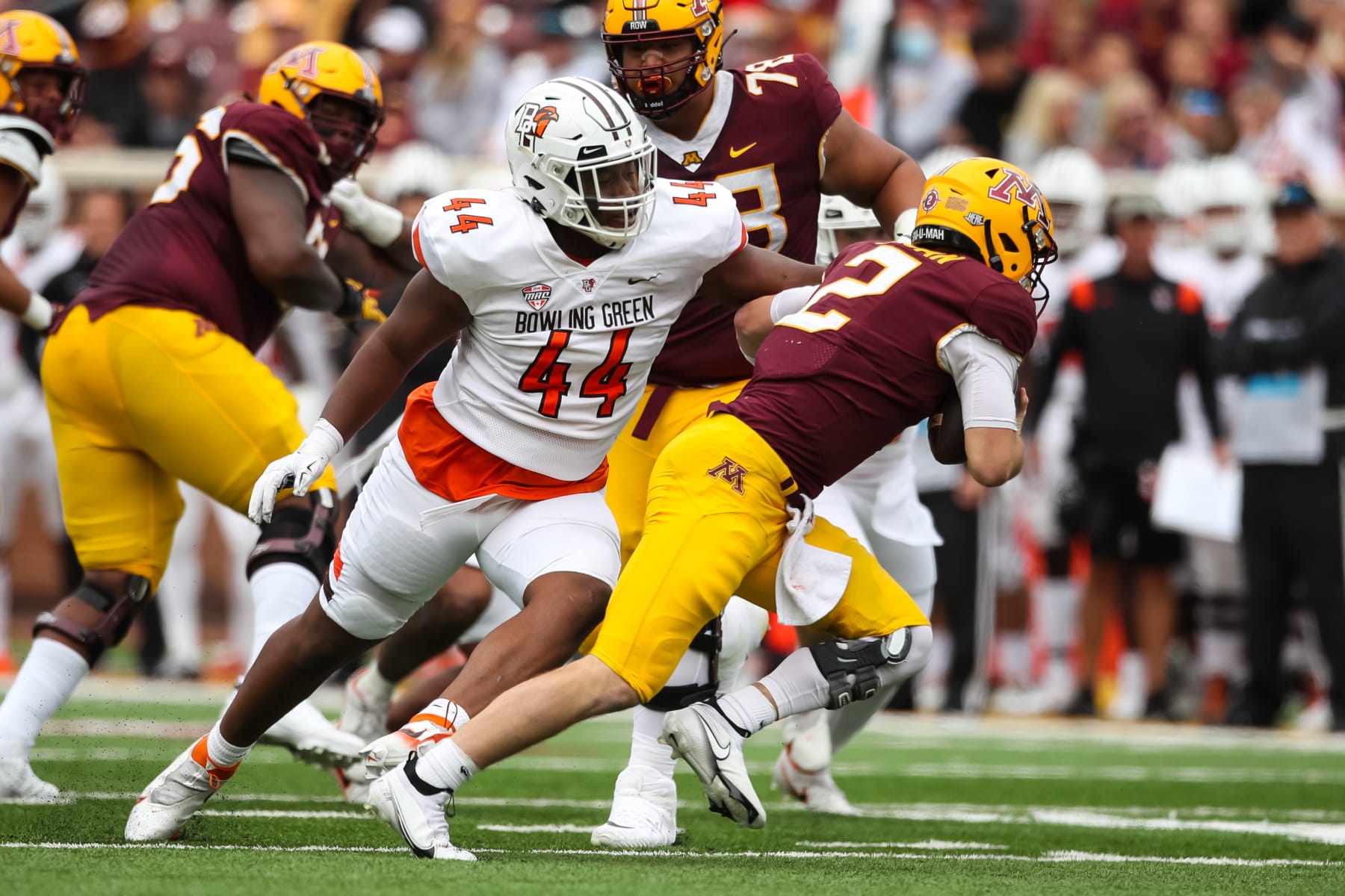 MINNEAPOLIS, MN - SEPTEMBER 25: Tanner Morgan #2 of the Minnesota Golden Gophers avoids a rush by Karl Brooks #44 of the Bowling Green Falcons in the second quarter of the game at Huntington Bank Stadium on September 25, 2021 in Minneapolis, Minnesota. The Falcons defeated the Golden Gophers 14-10. (Photo by David Berding/Getty Images)