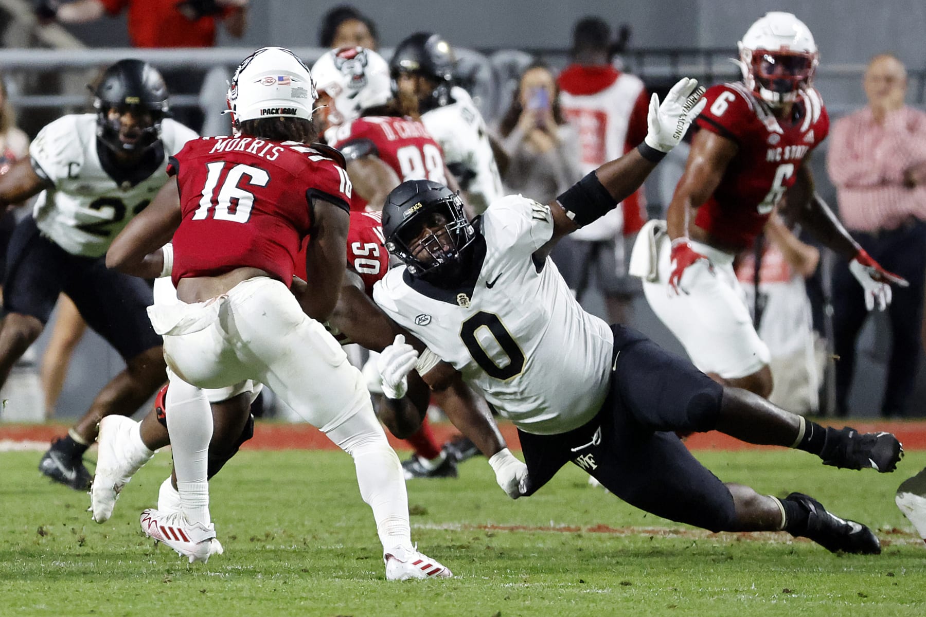 Wake Forest's Kobie Turner (0) rushes in on North Carolina State quarterback MJ Morris (16) during the first half of an NCAA college football game in Raleigh, N.C., Saturday, Nov. 5, 2022. (AP Photo/Karl B DeBlaker)