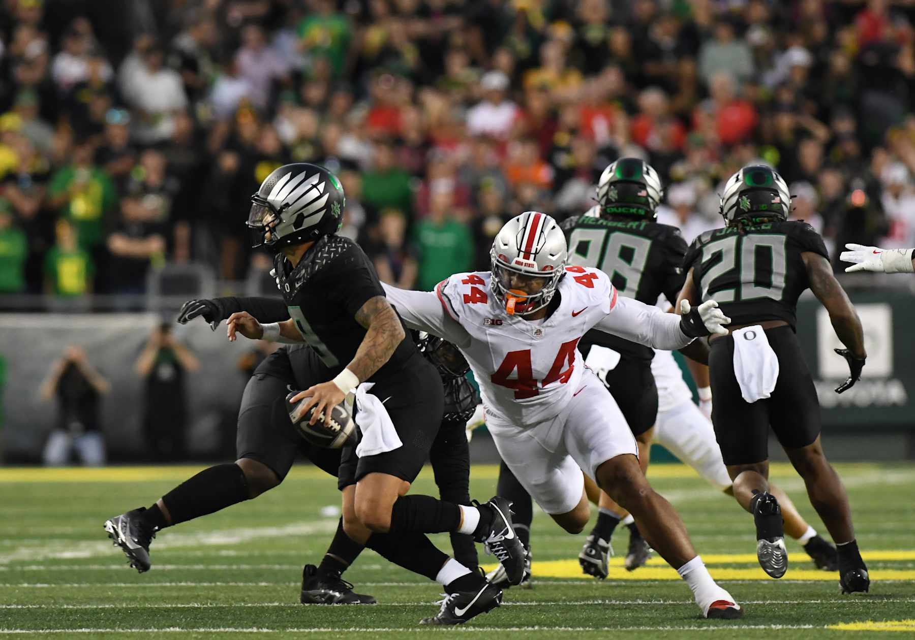 EUGENE, OR - OCTOBER 12: Ohio State Buckeyes defensive end JT Tuimoloau (44) pressures Oregon Ducks quarterback Dillon Gabriel (8) during a college football game between the Ohio State Buckeyes and Oregon Ducks on October 12, 2024, at Autzen Stadium in Eugene, Oregon.(Photo by Brian Murphy/Icon Sportswire via Getty Images)