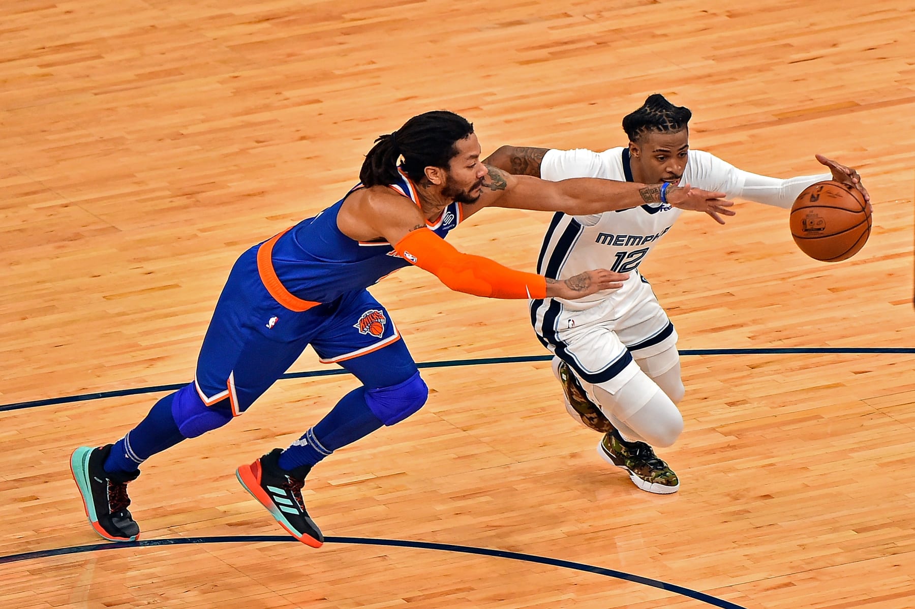 MEMPHIS, TENNESSEE - MAY 03: Ja Morant #12 of the Memphis Grizzlies drives to the basket against Derrick Rose #4 of the New York Knicks during the first half at FedExForum on May 03, 2021 in Memphis, Tennessee. NOTE TO USER: User expressly acknowledges and agrees that, by downloading and or using this photograph, User is consenting to the terms and conditions of the Getty Images License Agreement. (Photo by Justin Ford/Getty Images)