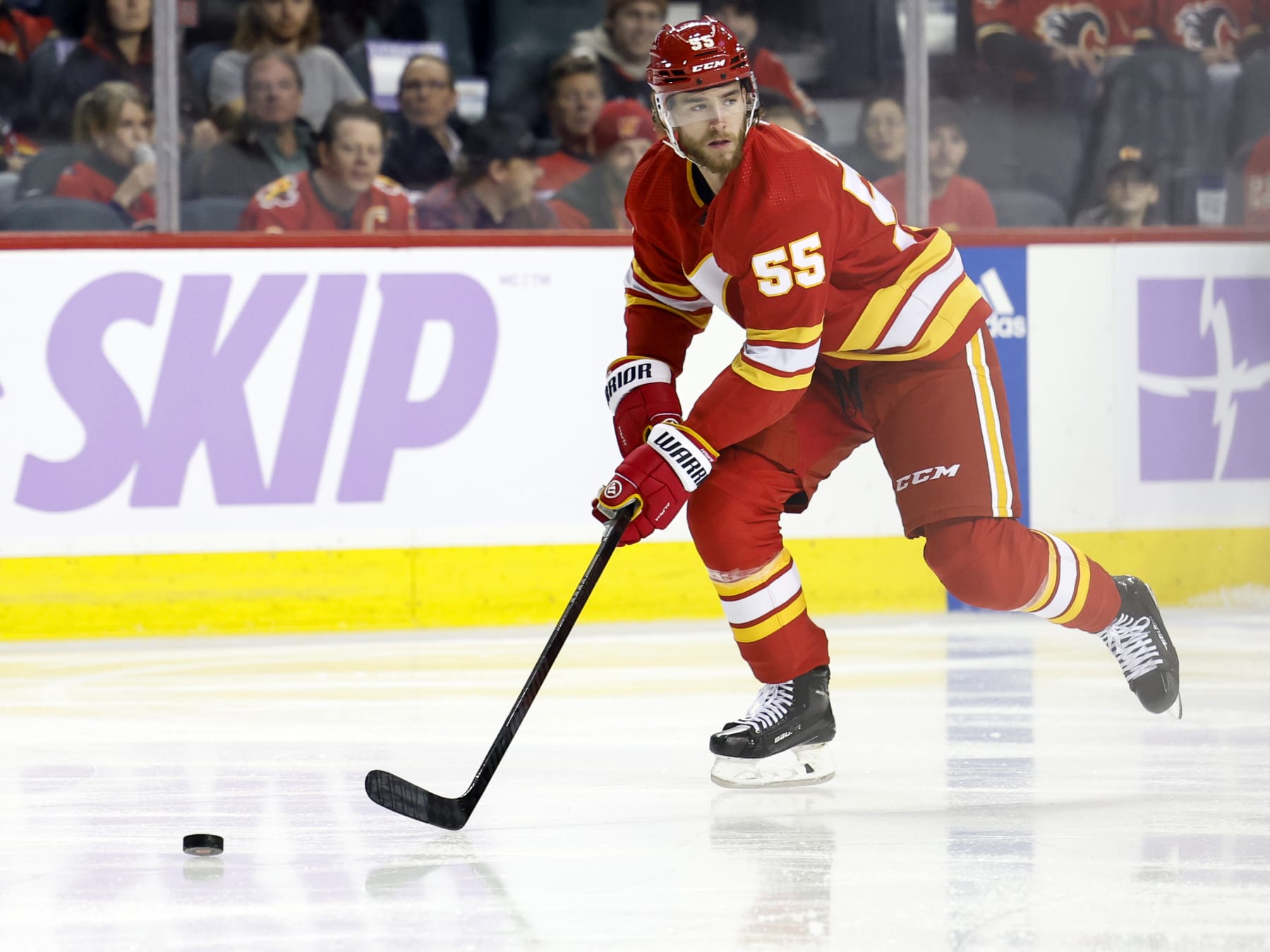 CALGARY, CANADA - NOVEMBER 27:  Noah Hanifin #55 of the Calgary Flames carries the puck up ice during the game against the Vegas Golden Knights at the Scotiabank Saddledome on November 27, 2023 in Calgary, Alberta, Canada. (Photo by Leah Hennel/Getty Images)