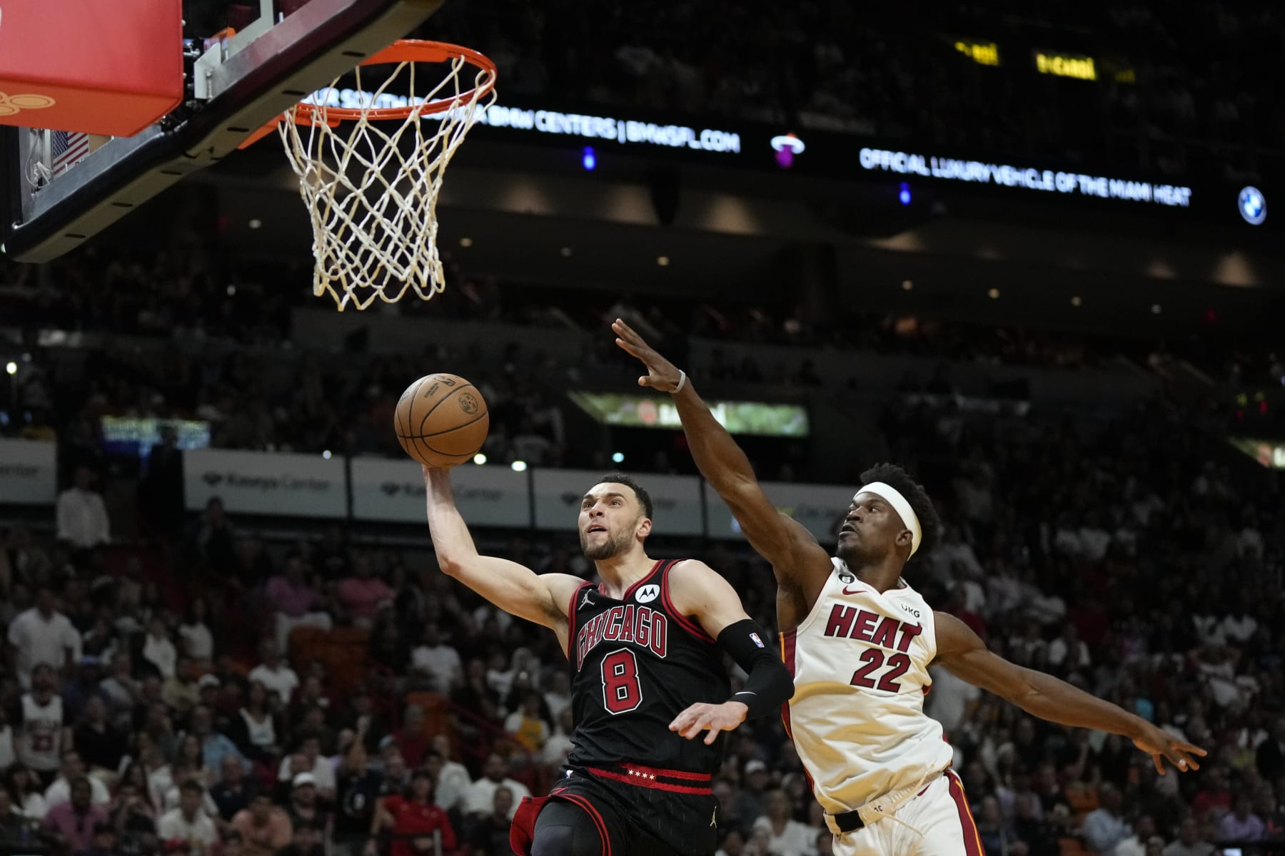 Chicago Bulls guard Zach LaVine (8) goes for the basket while defended by Miami Heat forward Jimmy Butler (22) during the second half of an NBA basketball play-in tournament game, Friday, April 14, 2023, in Miami. (AP Photo/Rebecca Blackwell)