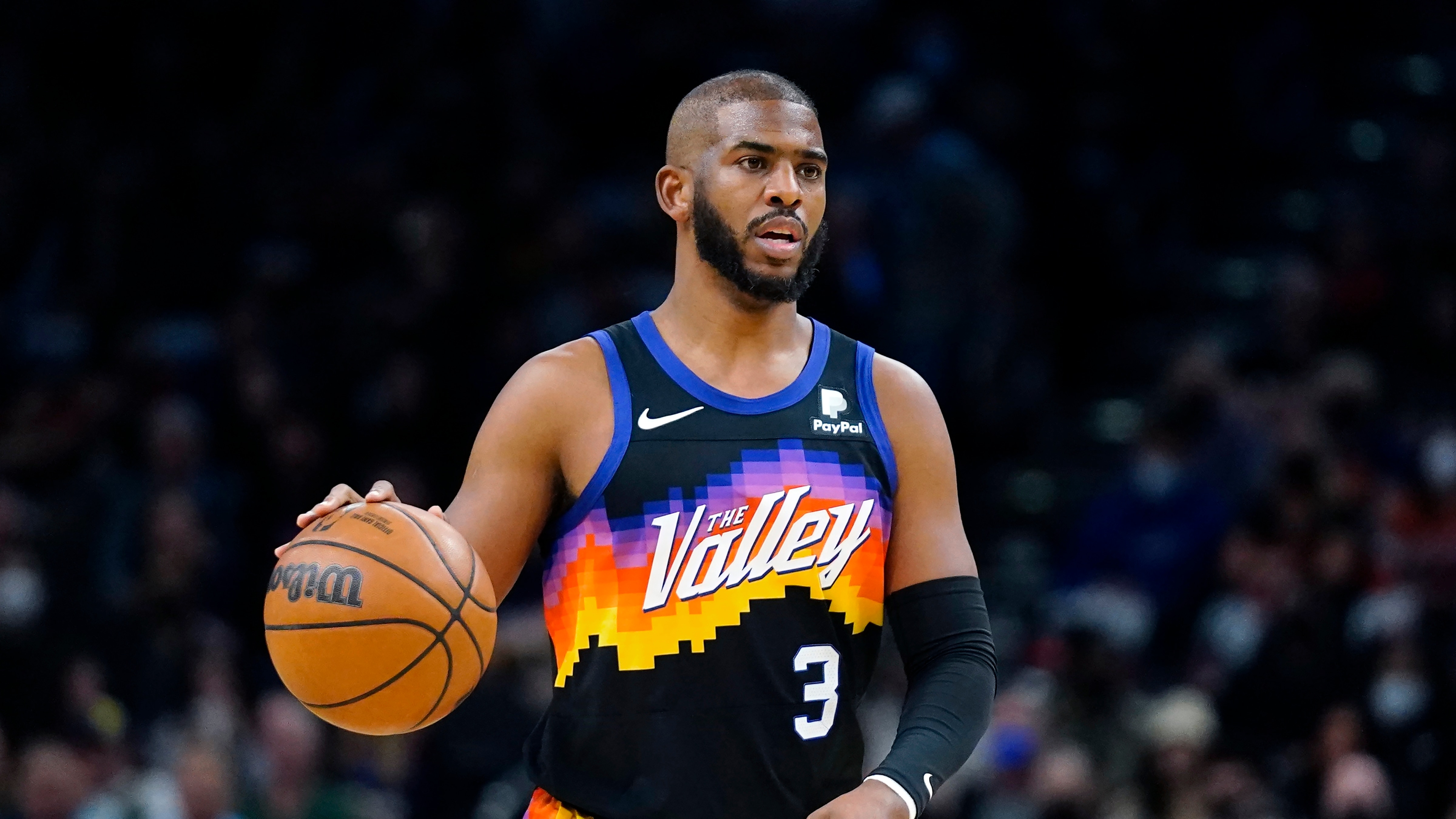 Phoenix Suns guard Chris Paul dribbles the ball against the Milwaukee Bucks during the first half of an NBA basketball game Thursday, Feb. 10, 2022, in Phoenix. (AP Photo/Ross D. Franklin)