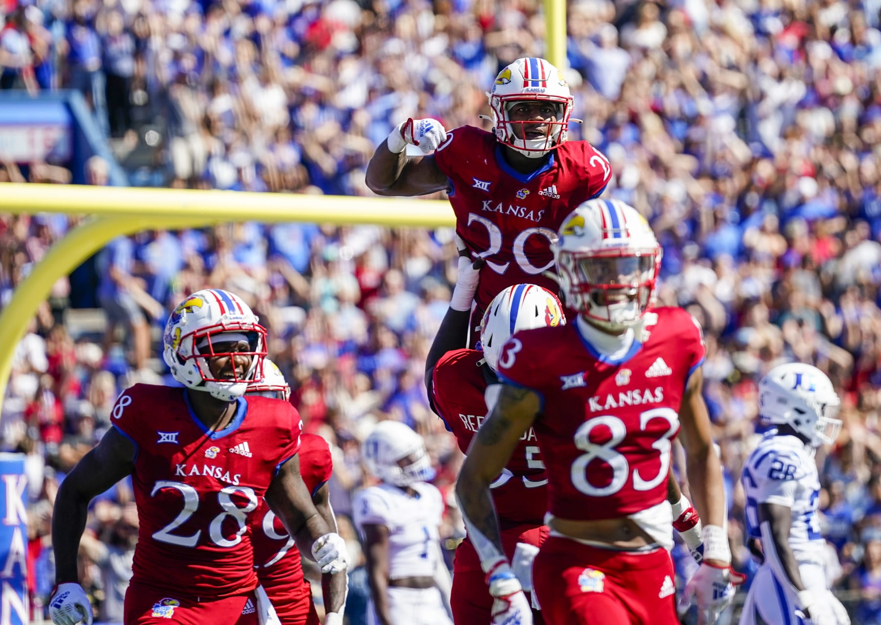 LAWRENCE, KS - SEPTEMBER 24: Daniel Hishaw Jr. #20 of the Kansas Jayhawks celebrates with teammates after scoring a touchdown against the Duke Blue Devils during the first half at David Booth Kansas Memorial Stadium on September 24, 2022 in Lawrence, Kansas. (Photo by Jay Biggerstaff/Getty Images)