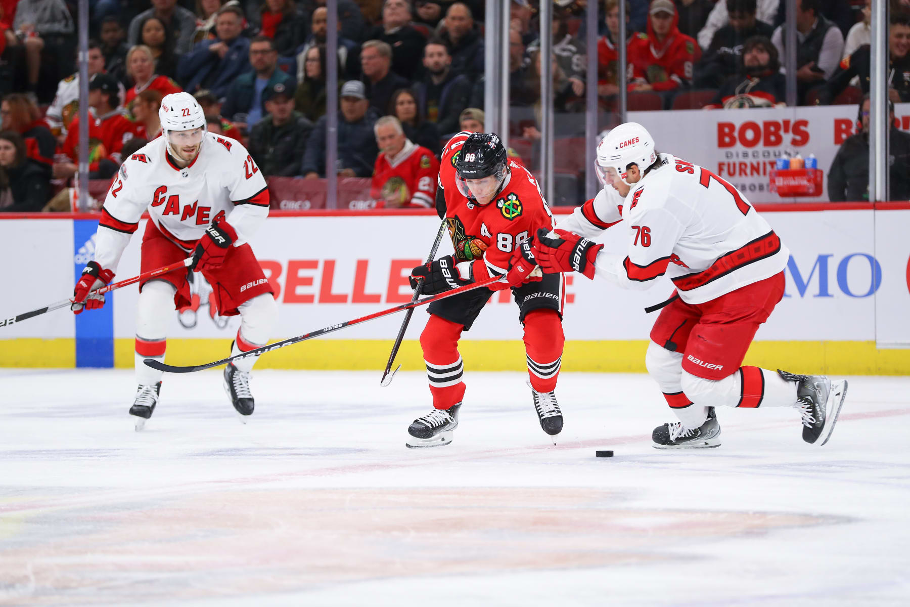 CHICAGO, IL - NOVEMBER 14: Chicago Blackhawks right wing Patrick Kane (88) and Carolina Hurricanes defenseman Brady Skjei (76) battle for position during a game between the Carolina Hurricanes and the Chicago Blackhawks on November 14, 2022 at the United Center in Chicago, IL. (Photo by Melissa Tamez/Icon Sportswire via Getty Images)