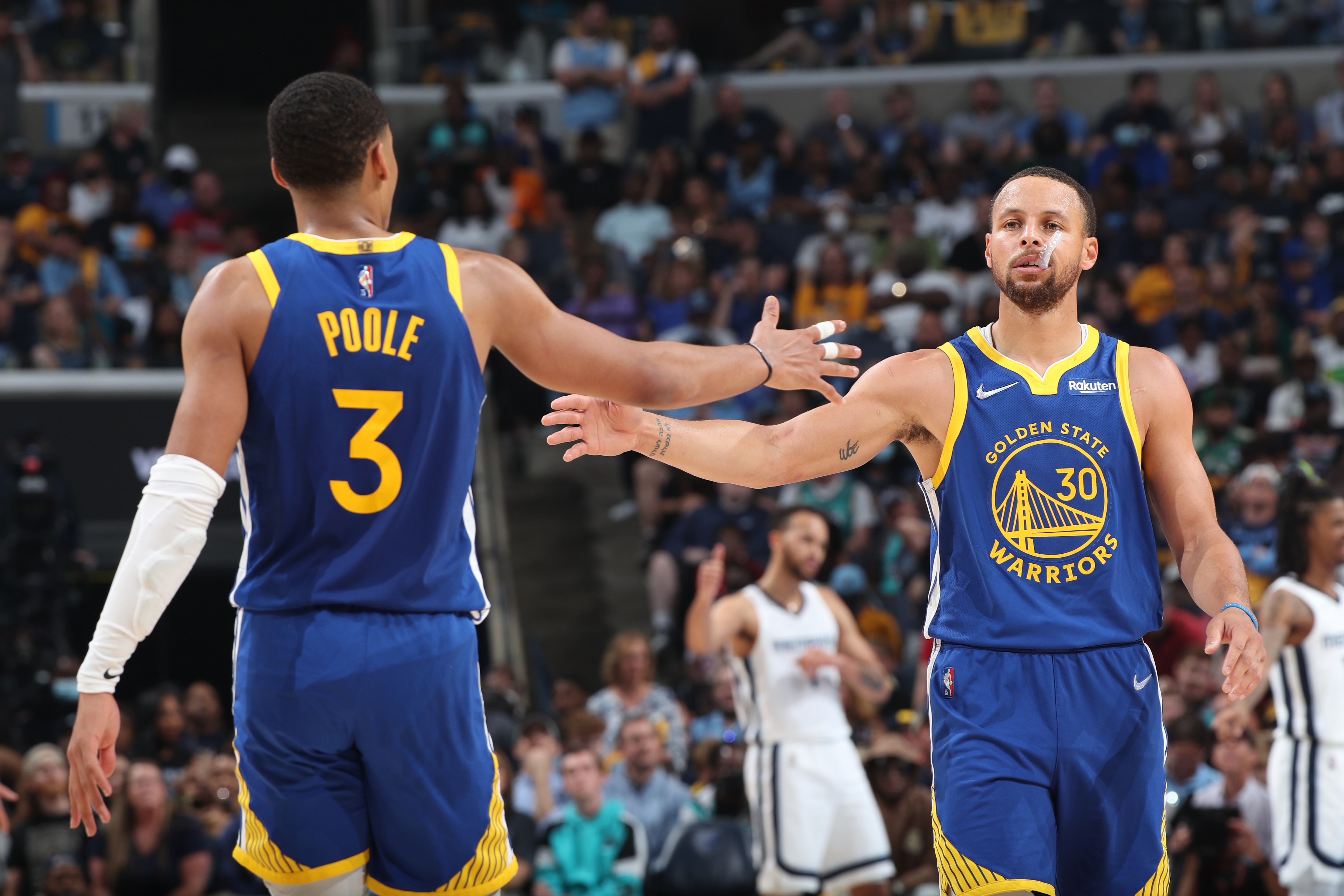 MEMPHIS, TN - MAY 1: Jordan Poole #3 hi-fives Stephen Curry #30 of the Golden State Warriors during Game 1 of the 2022 NBA Playoffs Western Conference Semifinals on May 1, 2022 at FedExForum in Memphis, Tennessee. NOTE TO USER: User expressly acknowledges and agrees that, by downloading and or using this photograph, User is consenting to the terms and conditions of the Getty Images License Agreement. Mandatory Copyright Notice: Copyright 2022 NBAE (Photo by Joe Murphy/NBAE via Getty Images)