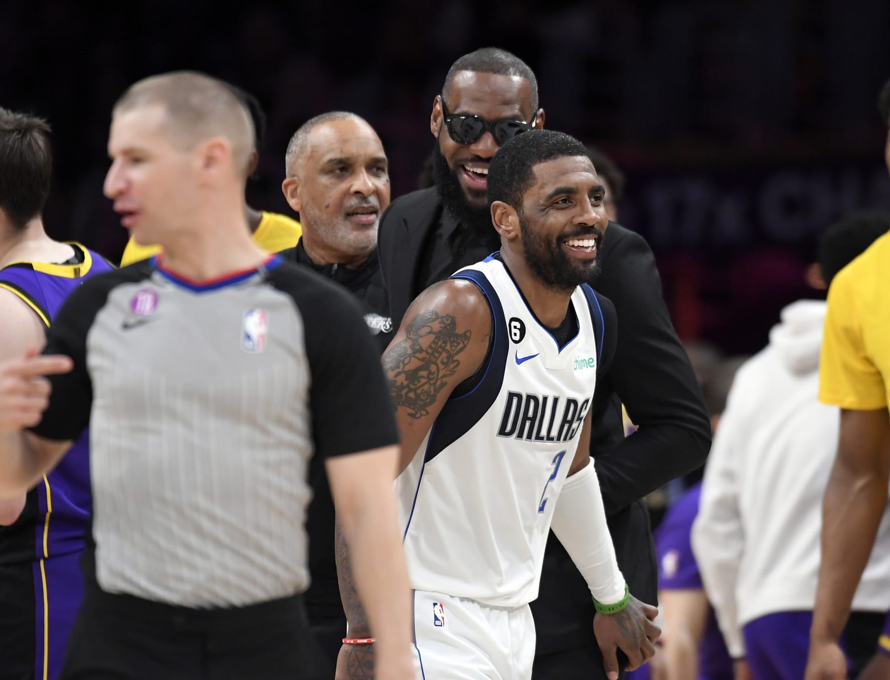 LOS ANGELES, CA - MARCH 17: Kyrie Irving #2 of the Dallas Mavericks greets LeBron James #6 of the Los Angeles Lakers during a timeout in the second half at Crypto.com Arena on March 17, 2023 in Los Angeles, California. NOTE TO USER: User expressly acknowledges and agrees that, by downloading and or using this photograph, User is consenting to the terms and conditions of the Getty Images License Agreement.(Photo by Kevork Djansezian/Getty Images)