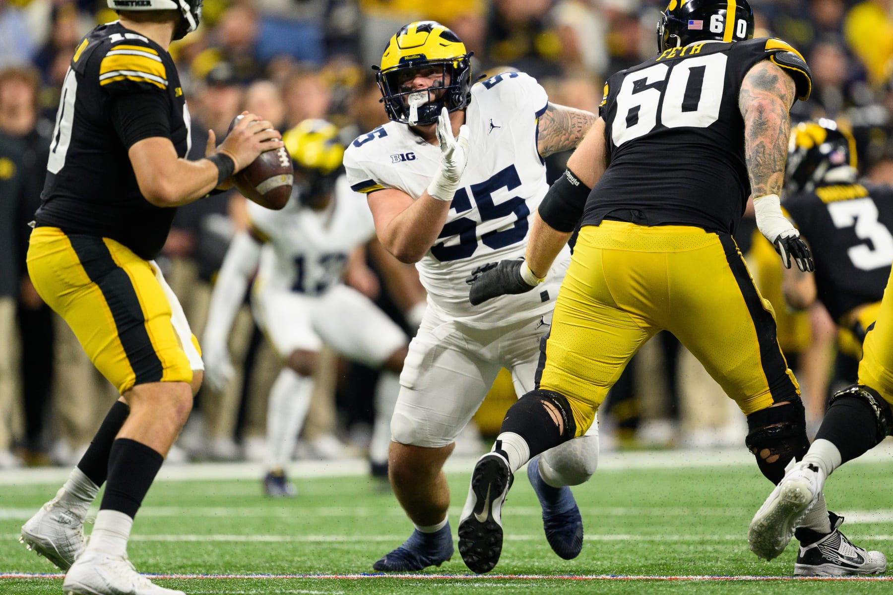 INDIANAPOLIS, IN - DECEMBER 02: Michigan Wolverines defensive lineman Mason Graham (55) rushes up the middle during the Big 10 Championship game between the Michigan Wolverines and Iowa Hawkeyes on December 2, 2023, at Lucas Oil Stadium in Indianapolis, IN. (Photo by Zach Bolinger/Icon Sportswire via Getty Images)