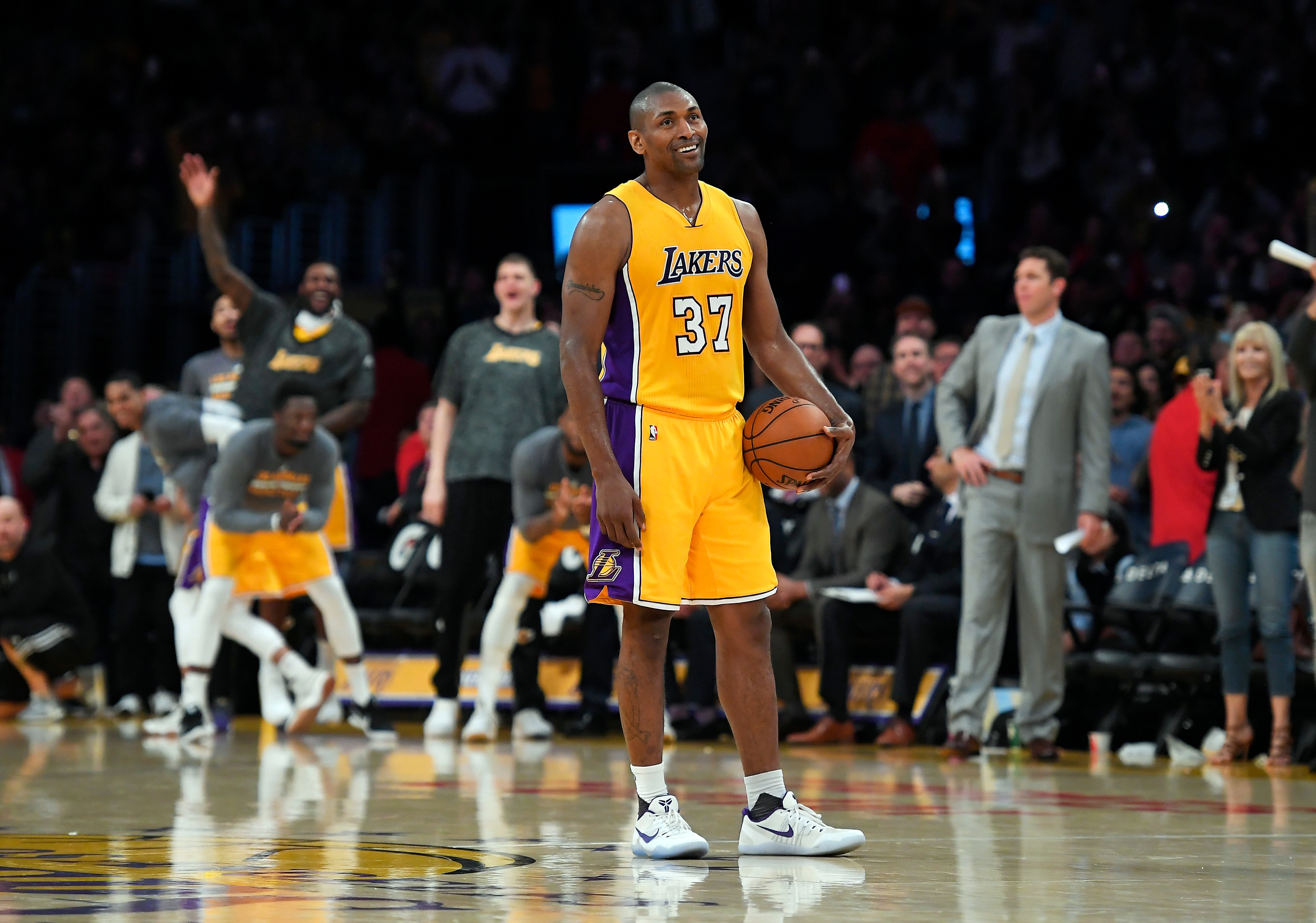 FILE - In this Tuesday, April 11, 2017, file photo, Los Angeles Lakers forward Metta World Peace stands on the court while teammates and fans cheer as the 24-second clock runs out near the end of the team's 108-96 victory against the New Orleans Pelicans in an NBA basketball game in Los Angeles. Metta World Peace needed to win a championship ring so his career wasn't defined only by one angry moment in Detroit. (AP Photo/Mark J. Terrill, File)