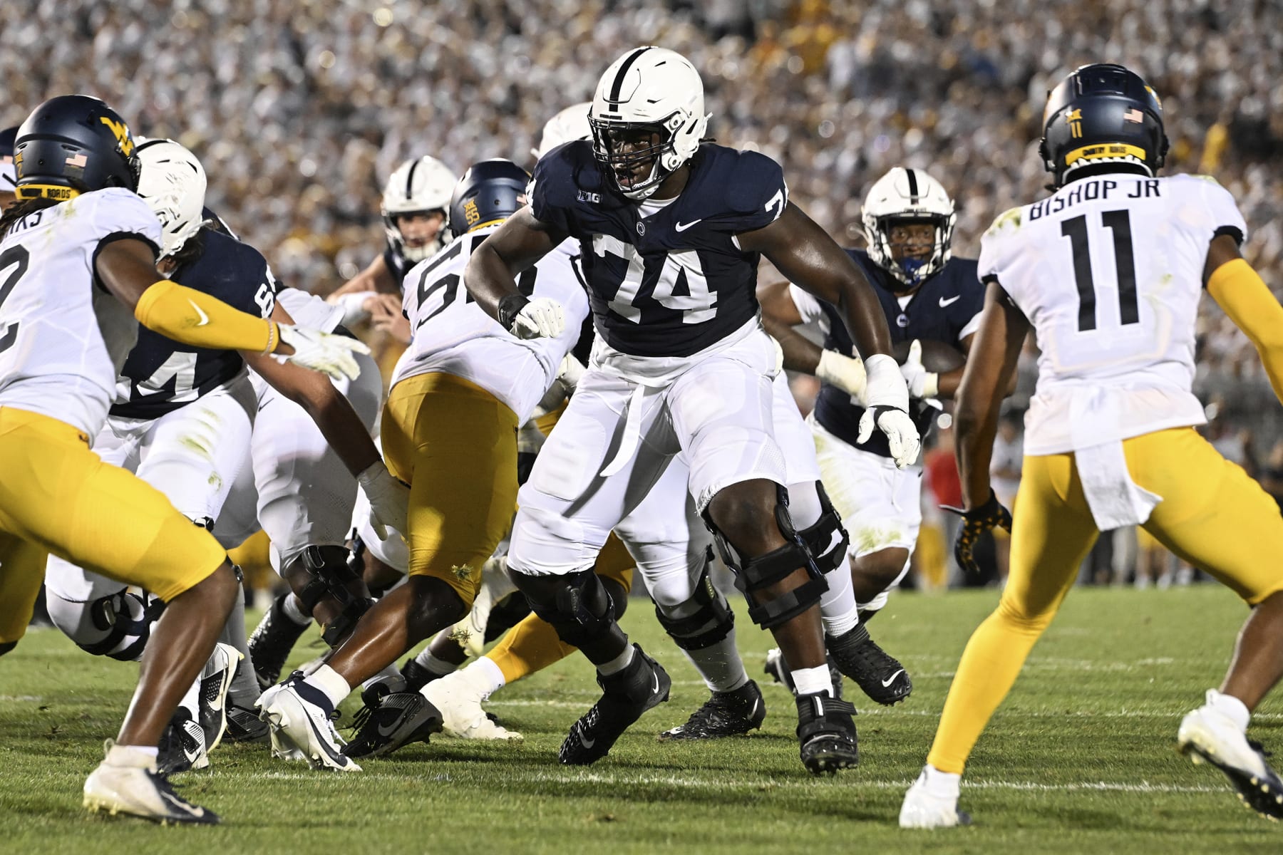 Penn State offensive lineman Olumuyiwa Fashanu (74) looks to block a West Virginia defender during an NCAA college football game, Saturday, Sept. 2, 2023, in State College, Pa. (AP Photo/Barry Reeger)