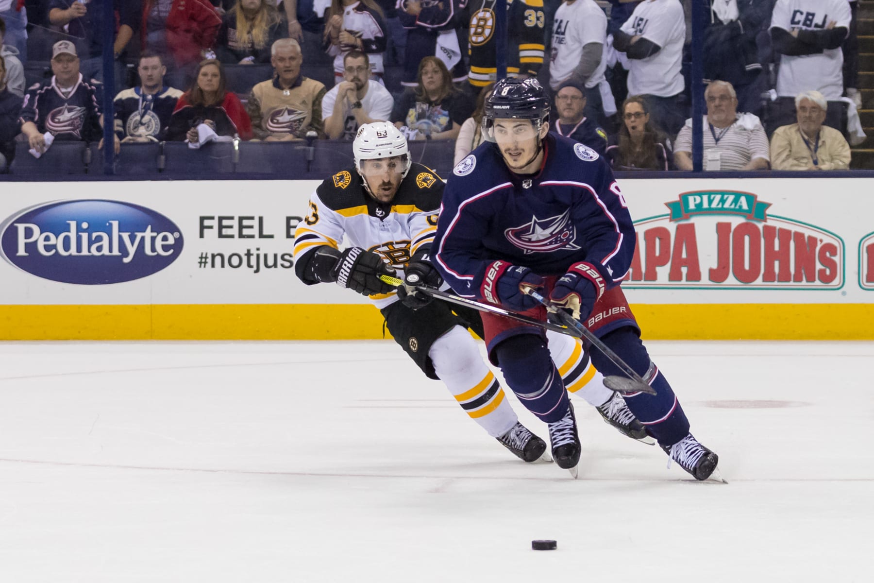 COLUMBUS, OH - MAY 06: Columbus Blue Jackets defenseman Zach Werenski (8) and Boston Bruins left wing Brad Marchand (63) battle for the puck in the Stanley Cup Eastern Conference semifinal playoff game between the Columbus Blue Jackets and the Boston Bruins on May 06, 2019 at Nationwide Arena in Columbus, OH. (Photo by Adam Lacy/Icon Sportswire via Getty Images)