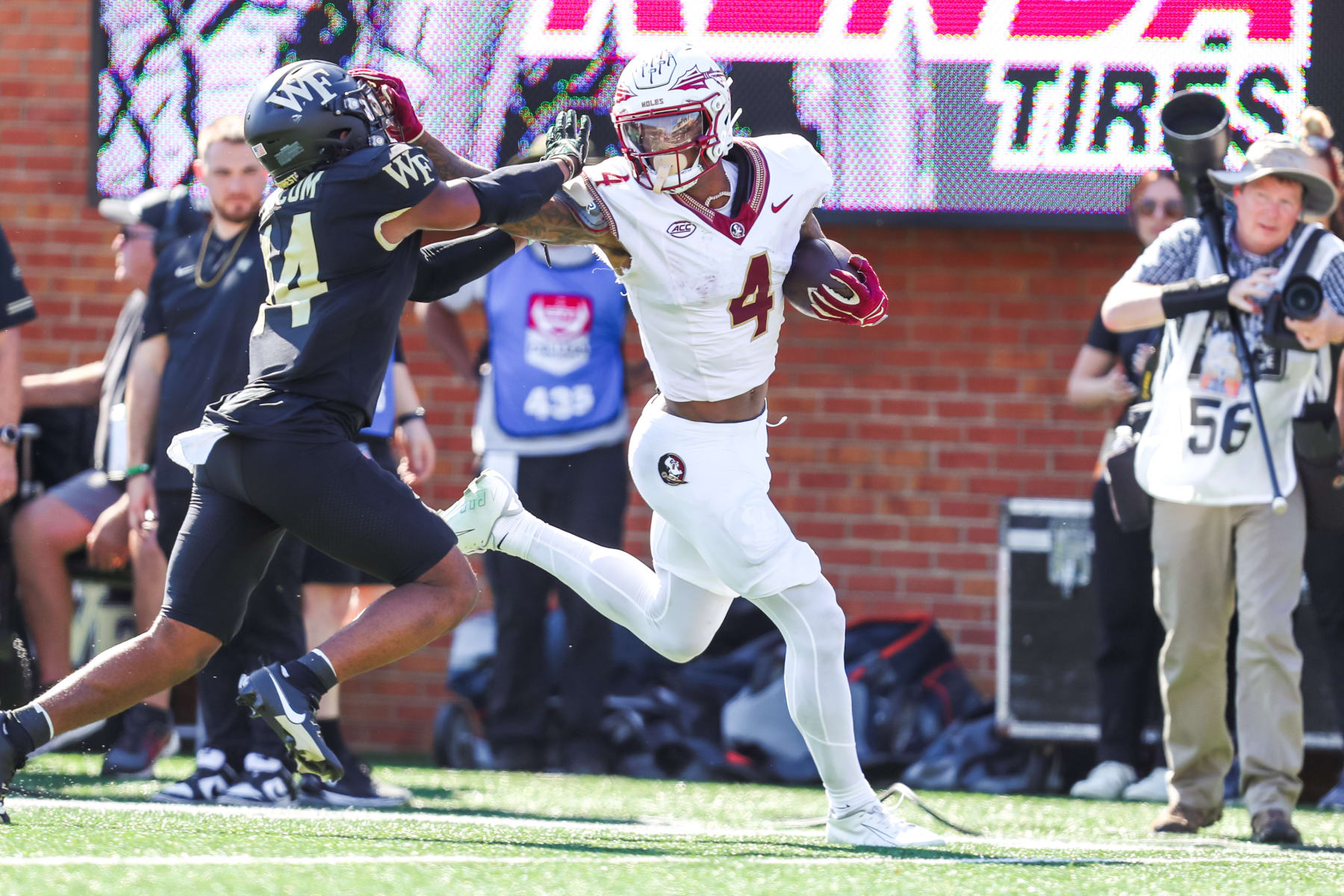 CHARLOTTE, NC - OCTOBER 28: Keon Coleman #4 of the Florida State Seminoles still arms Evan Slocum #14 of the Wake Forest Demon Deacons as he runs the ball during a football game at Allegacy Federal Credit Union Stadium in Winston-Salem, North Carolina on Oct 28, 2023. (Photo by David Jensen/Icon Sportswire via Getty Images)