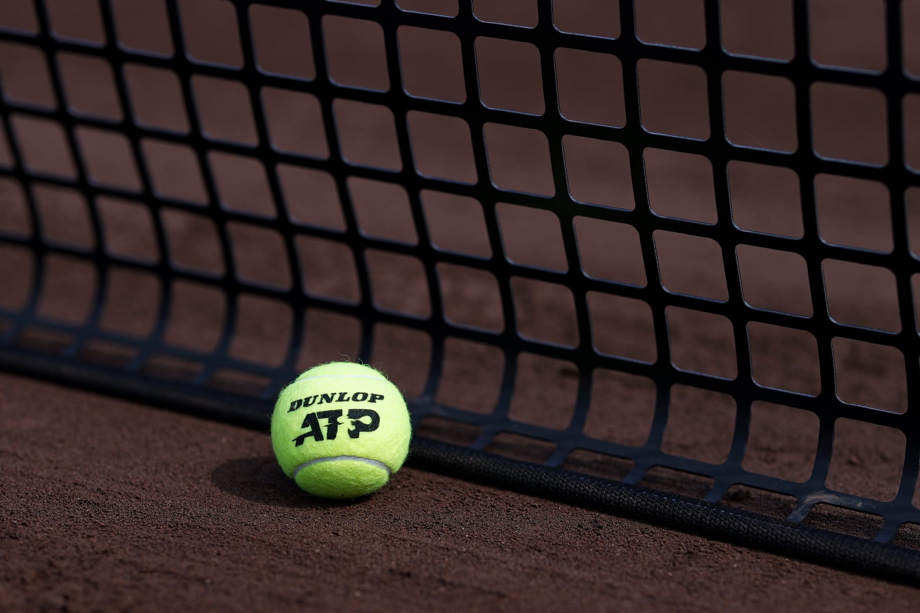 HOUSTON, TEXAS - APRIL 7: A Dunlop branded ATP tennis ball is displayed at the net on Day 10 of the U.S. Mens Clay Court Championships at River Oaks Country Club on April 7, 2024 in Houston, Texas. (Photo by Aaron M. Sprecher/Getty Images)