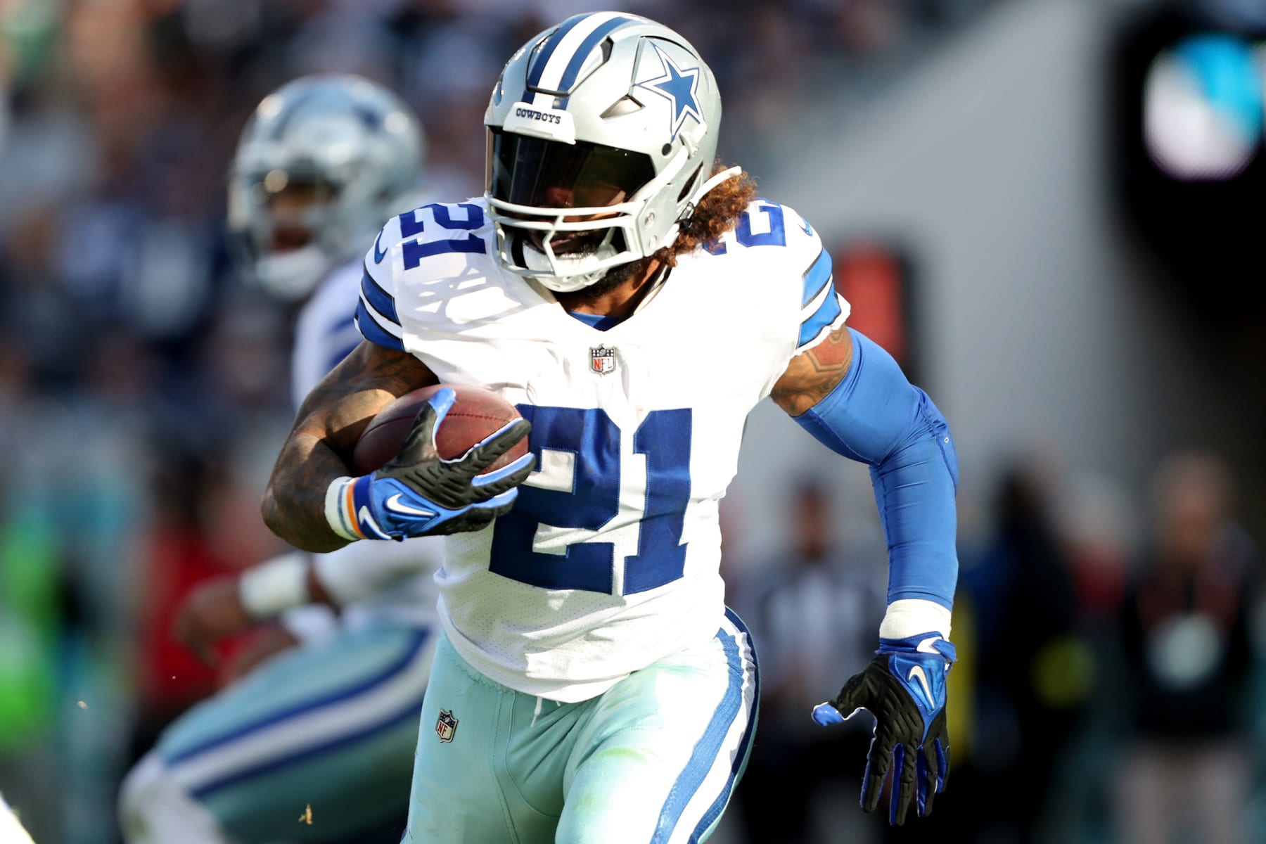 JACKSONVILLE, FLORIDA - DECEMBER 18: Ezekiel Elliott #21 of the Dallas Cowboys carries the ball against the Jacksonville Jaguars during the second half at TIAA Bank Field on December 18, 2022 in Jacksonville, Florida. (Photo by Courtney Culbreath/Getty Images)