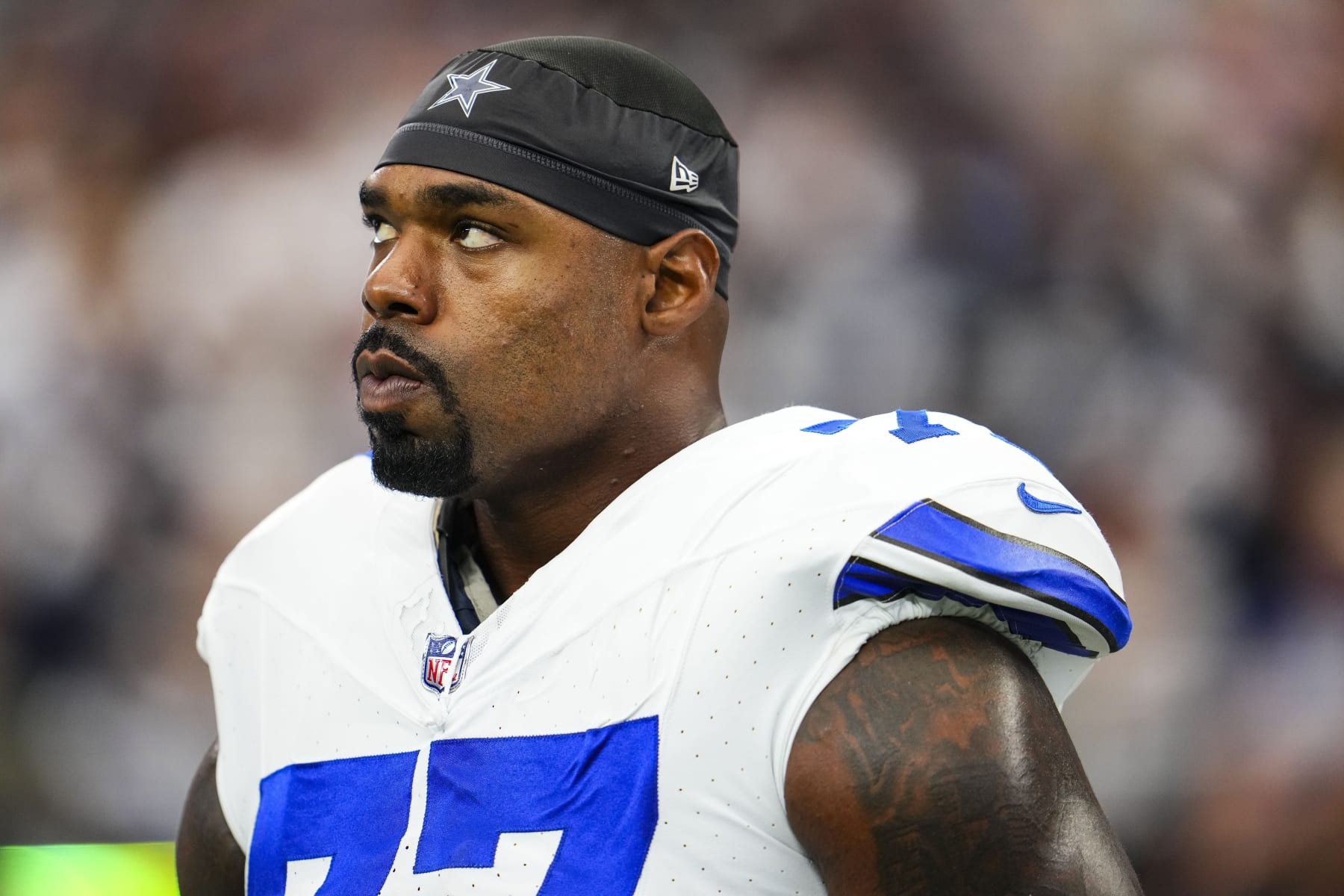 ARLINGTON, TX - SEPTEMBER 17: Tyron Smith #77 of the Dallas Cowboys looks on from the sideline prior to a football game at AT&T Stadium on September 17, 2023 in Arlington, Texas. (Photo by Cooper Neill/Getty Images)