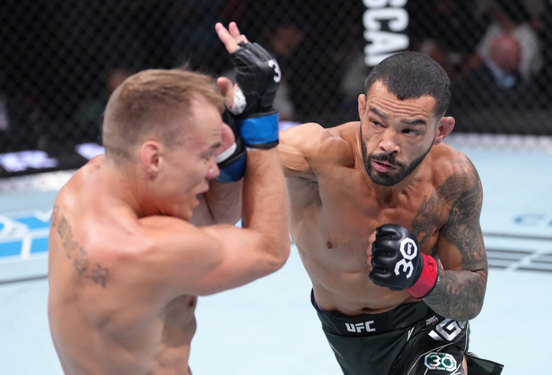 VANCOUVER, BRITISH COLUMBIA - JUNE 10:  (R-L) Dan Ige punches Nate Landwehr in their featherweight fight during the UFC 289 event at Rogers Arena on June 10, 2023 in Vancouver, Canada. (Photo by Jeff Bottari/Zuffa LLC)