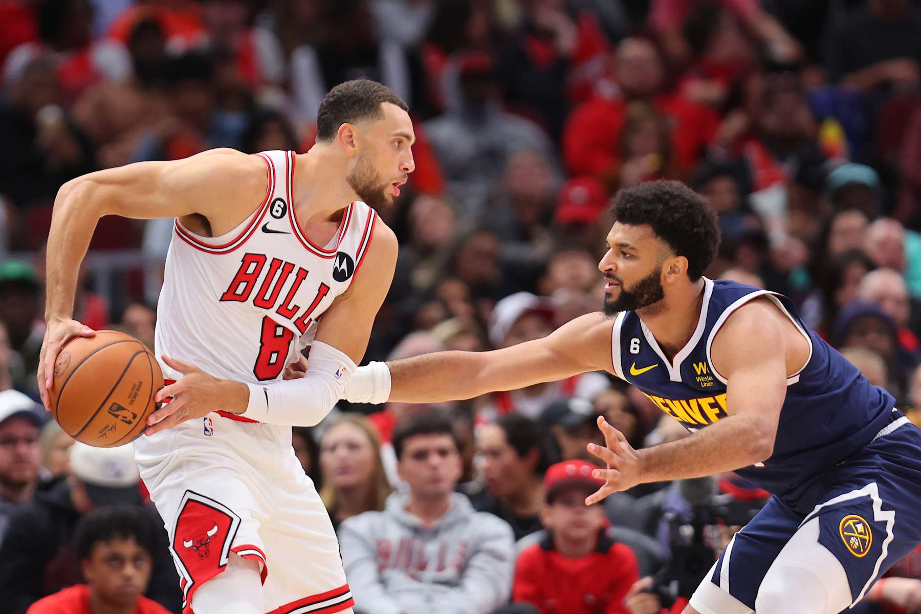 CHICAGO, ILLINOIS - OCTOBER 07: Zach LaVine #8 of the Chicago Bulls is defended by Jamal Murray #27 of the Denver Nuggets during the first half of a preseason game at the United Center on October 07, 2022 in Chicago, Illinois. NOTE TO USER: User expressly acknowledges and agrees that, by downloading and or using this photograph, User is consenting to the terms and conditions of the Getty Images License Agreement.  (Photo by Michael Reaves/Getty Images)