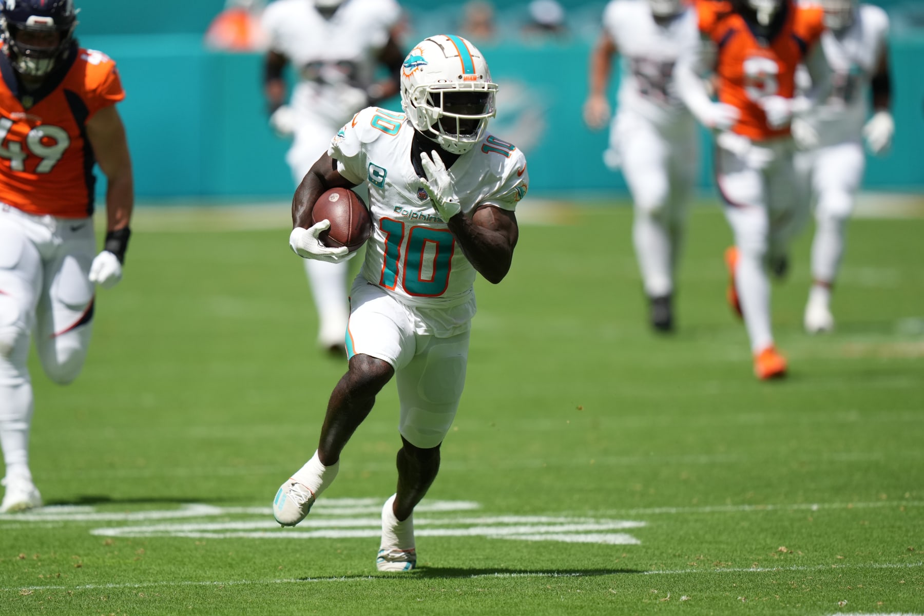 MIAMI GARDENS, FL - SEPTEMBER 24: Miami Dolphins wide receiver Tyreek Hill (10) runs for a touchdown in the first quarter during the game between the Denver Broncos and the Miami Dolphins on Sunday, September 24, 2023 at Hard Rock Stadium, Miami, Fla. (Photo by Peter Joneleit/Icon Sportswire via Getty Images)