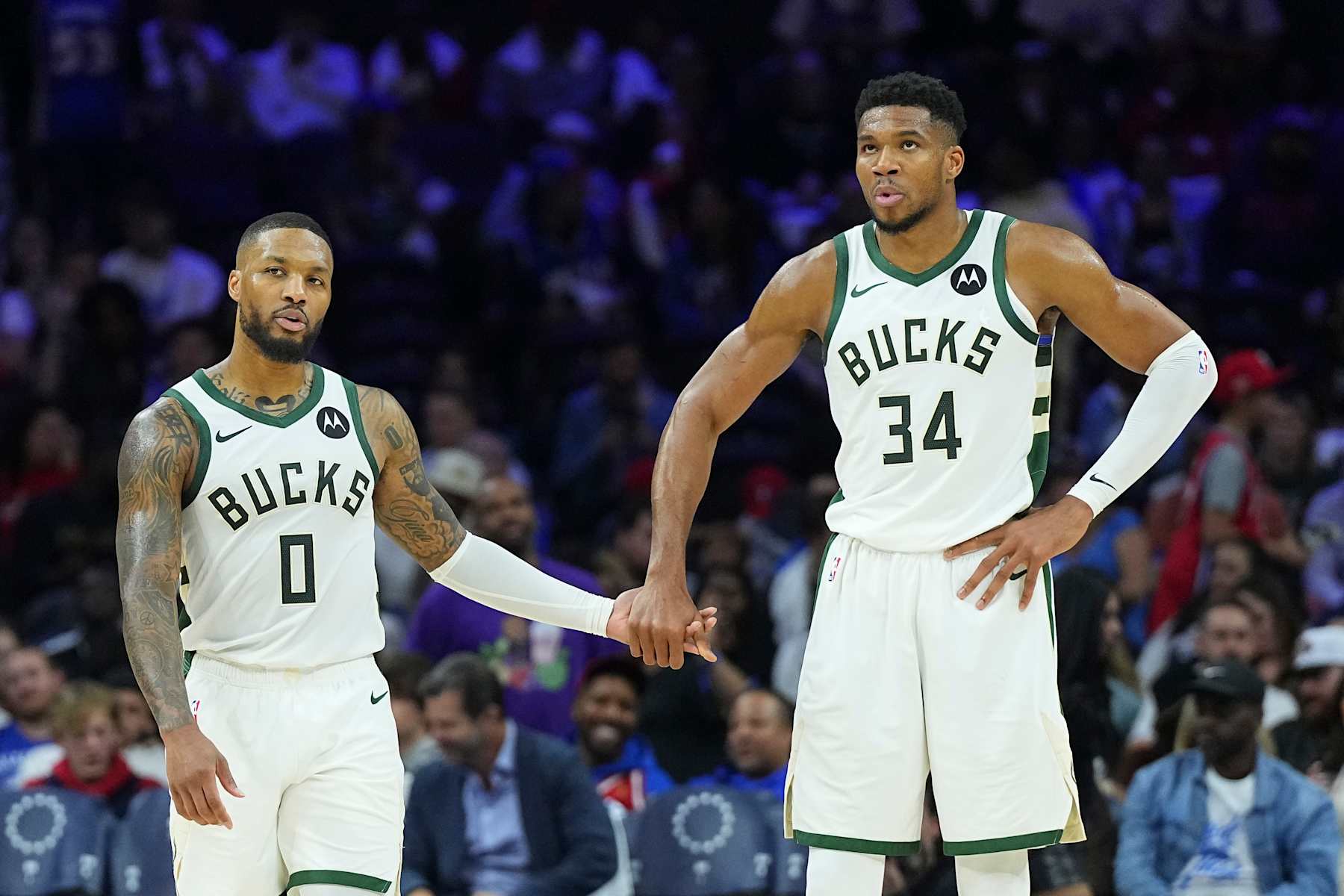 PHILADELPHIA, PENNSYLVANIA - OCTOBER 23: Damian Lillard #0 of the Milwaukee Bucks celebrates with Giannis Antetokounmpo #34 against the Philadelphia 76ers in the second half at the Wells Fargo Center on October 23, 2024 in Philadelphia, Pennsylvania. The Bucks defeated the 76ers 124-109. NOTE TO USER: User expressly acknowledges and agrees that, by downloading and/or using this photograph, user is consenting to the terms and conditions of the Getty Images License Agreement. (Photo by Mitchell Leff/Getty Images)