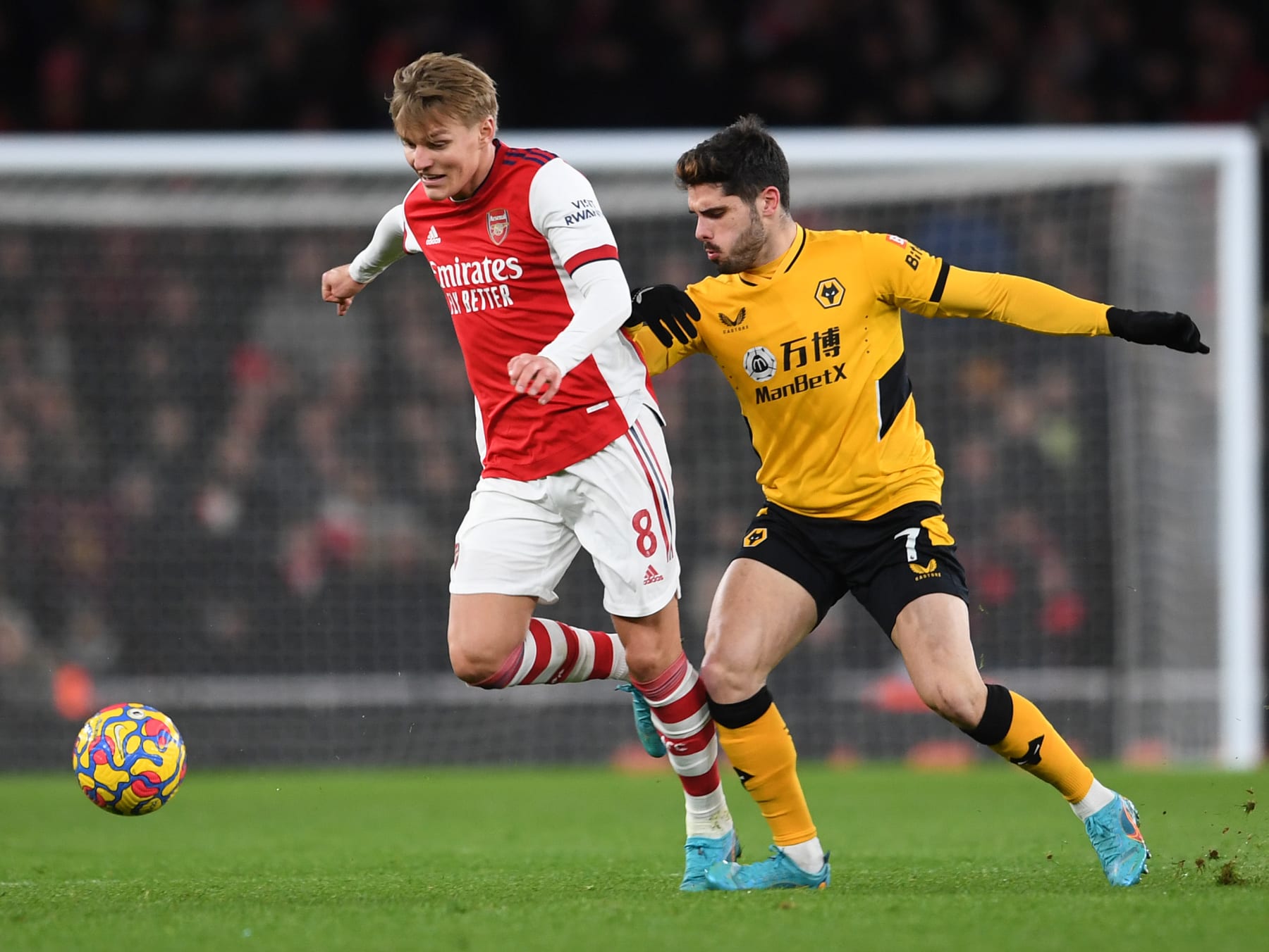 LONDON, ENGLAND - FEBRUARY 24: Martin Odegaard of Arsenal takes on Pedro Neto of Wolves during the Premier League match between Arsenal and Wolverhampton Wanderers at Emirates Stadium on February 24, 2022 in London, England. (Photo by David Price/Arsenal FC via Getty Images)