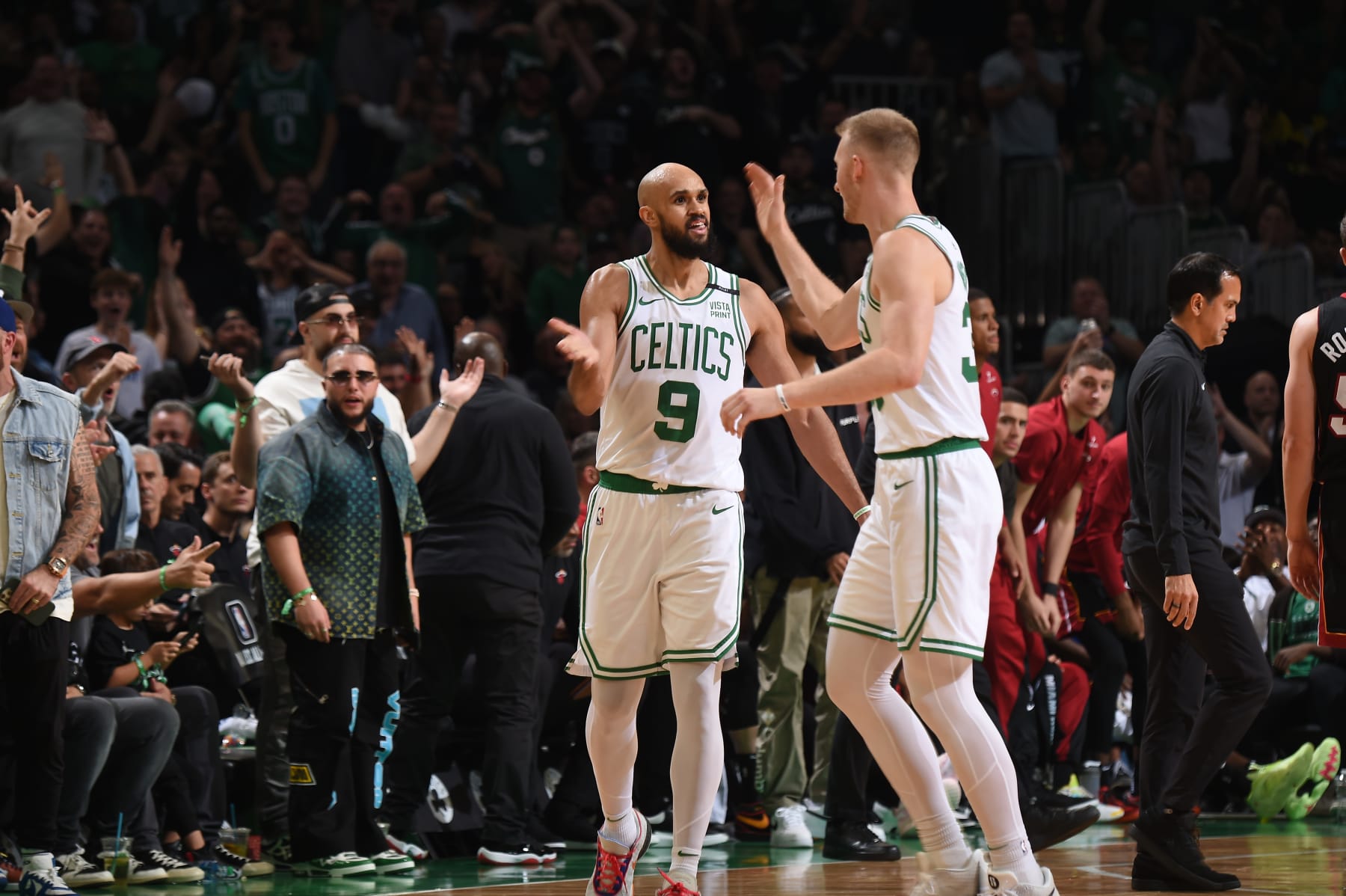 BOSTON, MA - OCTOBER 27: Derrick White #9 high fives Kristaps Porzingis #8 of the Boston Celtics during the game against the Miami Heat on October 27, 2023 at the TD Garden in Boston, Massachusetts. NOTE TO USER: User expressly acknowledges and agrees that, by downloading and or using this photograph, User is consenting to the terms and conditions of the Getty Images License Agreement. Mandatory Copyright Notice: Copyright 2023 NBAE (Photo by Brian Babineau/NBAE via Getty Images) BOSTON, MA - OCTOBER 27: Derrick White #9 high fives Kristaps Porzingis #8 of the Boston Celtics during the game against the Miami Heat on October 27, 2023 at the TD Garden in Boston, Massachusetts. NOTE TO USER: User expressly acknowledges and agrees that, by downloading and or using this photograph, User is consenting to the terms and conditions of the Getty Images License Agreement. Mandatory Copyright Notice: Copyright 2023 NBAE (Photo by Brian Babineau/NBAE via Getty Images)