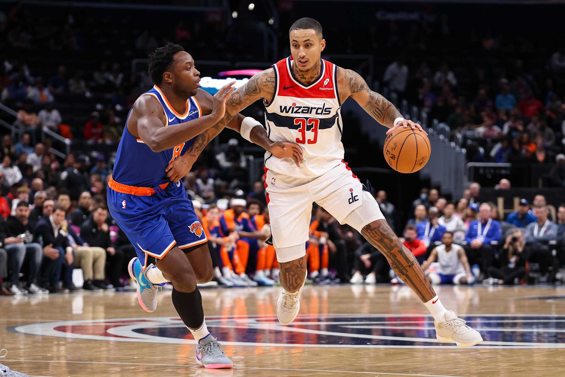 WASHINGTON, DC - OCTOBER 18: Kyle Kuzma #33 of the Washington Wizards brings the ball up court against OG Anunoby #8 of the New York Knicks during the first half of the preseason game at Capital One Arena on October 18, 2024 in Washington, DC. NOTE TO USER: User expressly acknowledges and agrees that, by downloading and or using this photograph, User is consenting to the terms and conditions of the Getty Images License Agreement. (Photo by Scott Taetsch/Getty Images)