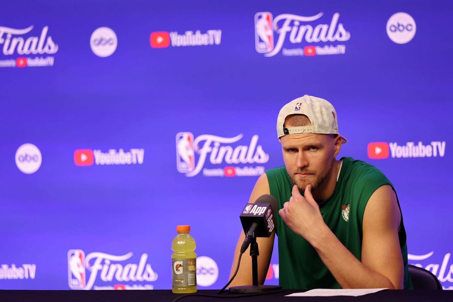 BOSTON, MASSACHUSETTS - JUNE 17: Kristaps Porzingis #8 of the Boston Celtics talks to media during a press conference after Boston's 106-88 win against the Dallas Mavericks in Game Five of the 2024 NBA Finals at TD Garden on June 17, 2024 in Boston, Massachusetts. NOTE TO USER: User expressly acknowledges and agrees that, by downloading and or using this photograph, User is consenting to the terms and conditions of the Getty Images License Agreement. (Photo by Adam Glanzman/Getty Images)
