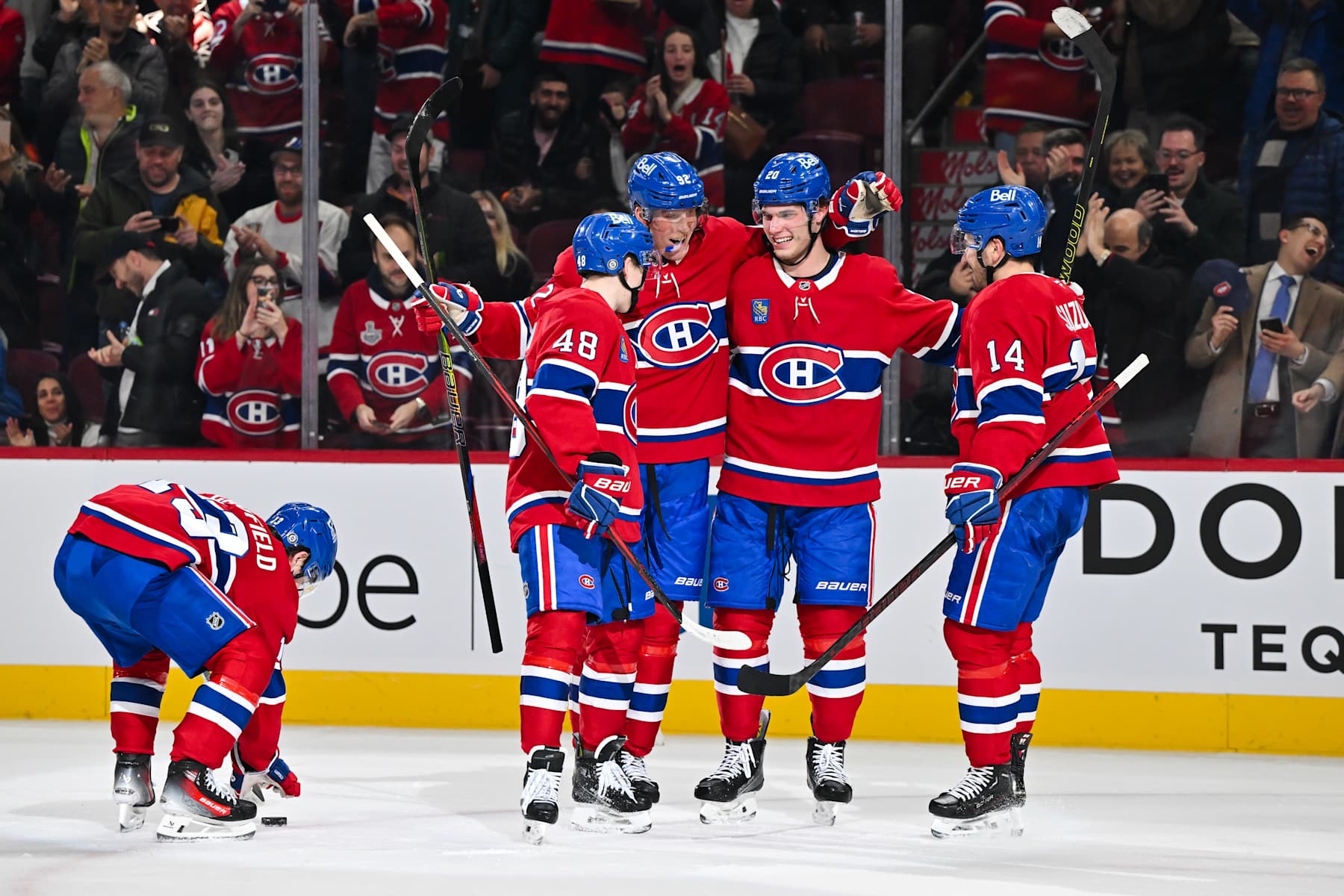MONTREAL, CANADA - DECEMBER 17:  Patrik Laine #92 of the Montreal Canadiens celebrates his hat-trick with teammates Cole Caufield #13, Lane Hutson #48, Juraj Slafkovsky #20 and Nick Suzuki #14 during the second period against the Buffalo Sabres at the Bell Centre on December 17, 2024 in Montreal, Quebec, Canada.  (Photo by Minas Panagiotakis/Getty Images)