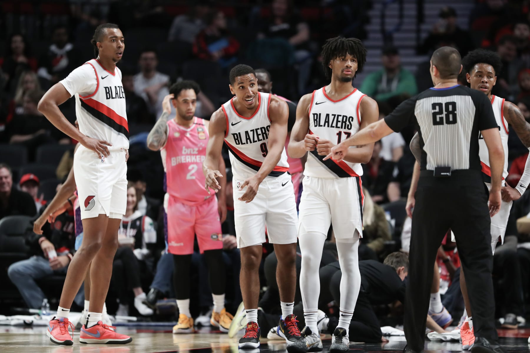 PORTLAND, OREGON - OCTOBER 10: Moses Brown #10, left, Malcolm Brogdon, center, and Shaedon Sharpe #17 of the Portland Trail Blazers, right, react to a call during the second quarter against the New Zealand Breakers at Moda Center on October 10, 2023 in Portland, Oregon. NOTE TO USER: User expressly acknowledges and agrees that, by downloading and/or using this Photograph, user is consenting to the terms and conditions of the Getty Images License Agreement. (Photo by Amanda Loman/Getty Images)