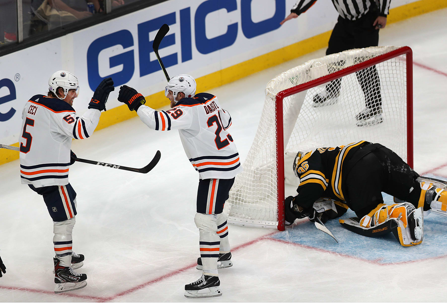 Boston - November 11: Boston Bruins goaltender Linus Ullmark (35) is down in the nest after Edmonton Oilers center Leon Draisaitl (29) scored a 3rd period goal to put the Oilers up 4-3. He is congratulated by Edmonton Oilers defenseman Cody Ceci (5). The Boston Bruins hosted the Edmonton Oilers in a regular season NHL hockey game at TD garden in Boston on November 11, 2021. (Photo by John Tlumacki/The Boston Globe via Getty Images)