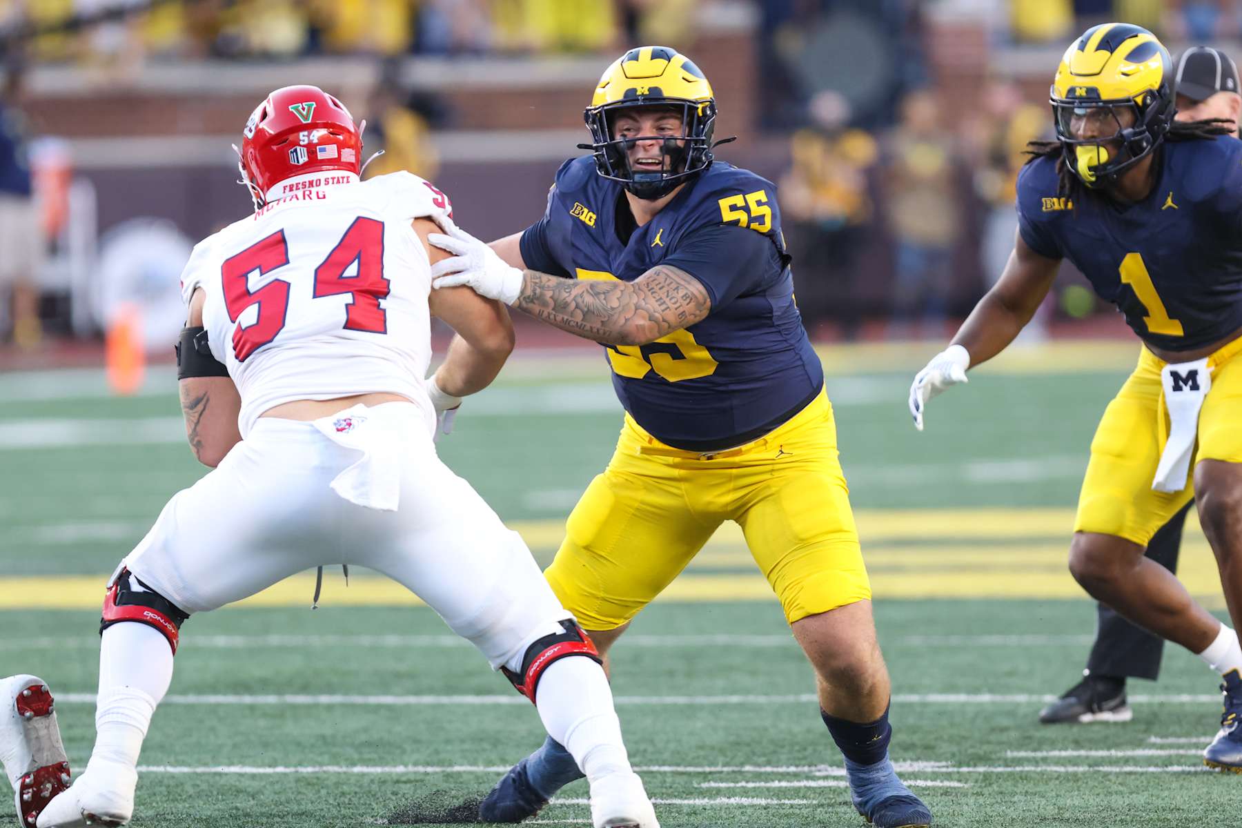 ANN ARBOR, MI - AUGUST 31: Michigan Wolverines defensive lineman Mason Graham (55) rushes during a play during the first quarter of non-conference college football game between the Fresno State Bullfrogs and the Michigan Wolverines on August 31, 2024 at Michigan Stadium in Ann Arbor, Michigan.  (Photo by Scott W. Grau/Icon Sportswire via Getty Images)