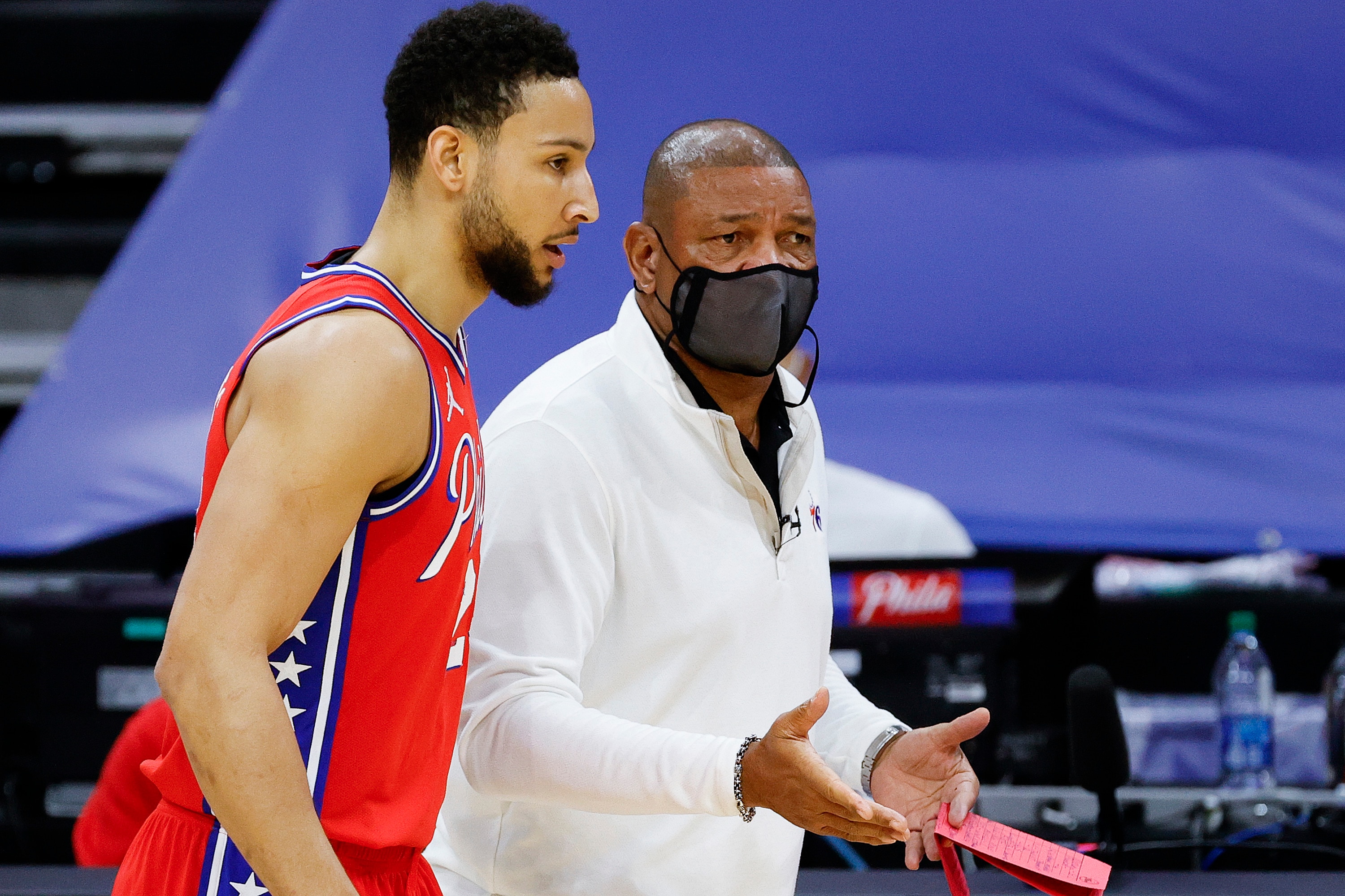 PHILADELPHIA, PENNSYLVANIA - JANUARY 27: Head coach Doc Rivers of the Philadelphia 76ers speaks with Ben Simmons #25 during the first quarter against the Los Angeles Lakers at Wells Fargo Center on January 27, 2021 in Philadelphia, Pennsylvania. NOTE TO USER: User expressly acknowledges and agrees that, by downloading and or using this photograph, User is consenting to the terms and conditions of the Getty Images License Agreement. (Photo by Tim Nwachukwu/Getty Images)