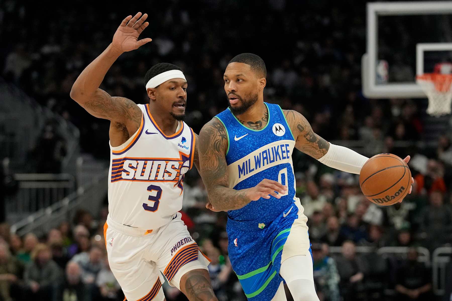 MILWAUKEE, WISCONSIN - MARCH 17: Damian Lillard #0 of the Milwaukee Bucks dribbles the ball against Bradley Beal #3 of the Phoenix Suns during the first half at Fiserv Forum on March 17, 2024 in Milwaukee, Wisconsin. NOTE TO USER: User expressly acknowledges and agrees that, by downloading and or using this photograph, User is consenting to the terms and conditions of the Getty Images License Agreement. (Photo by Patrick McDermott/Getty Images)