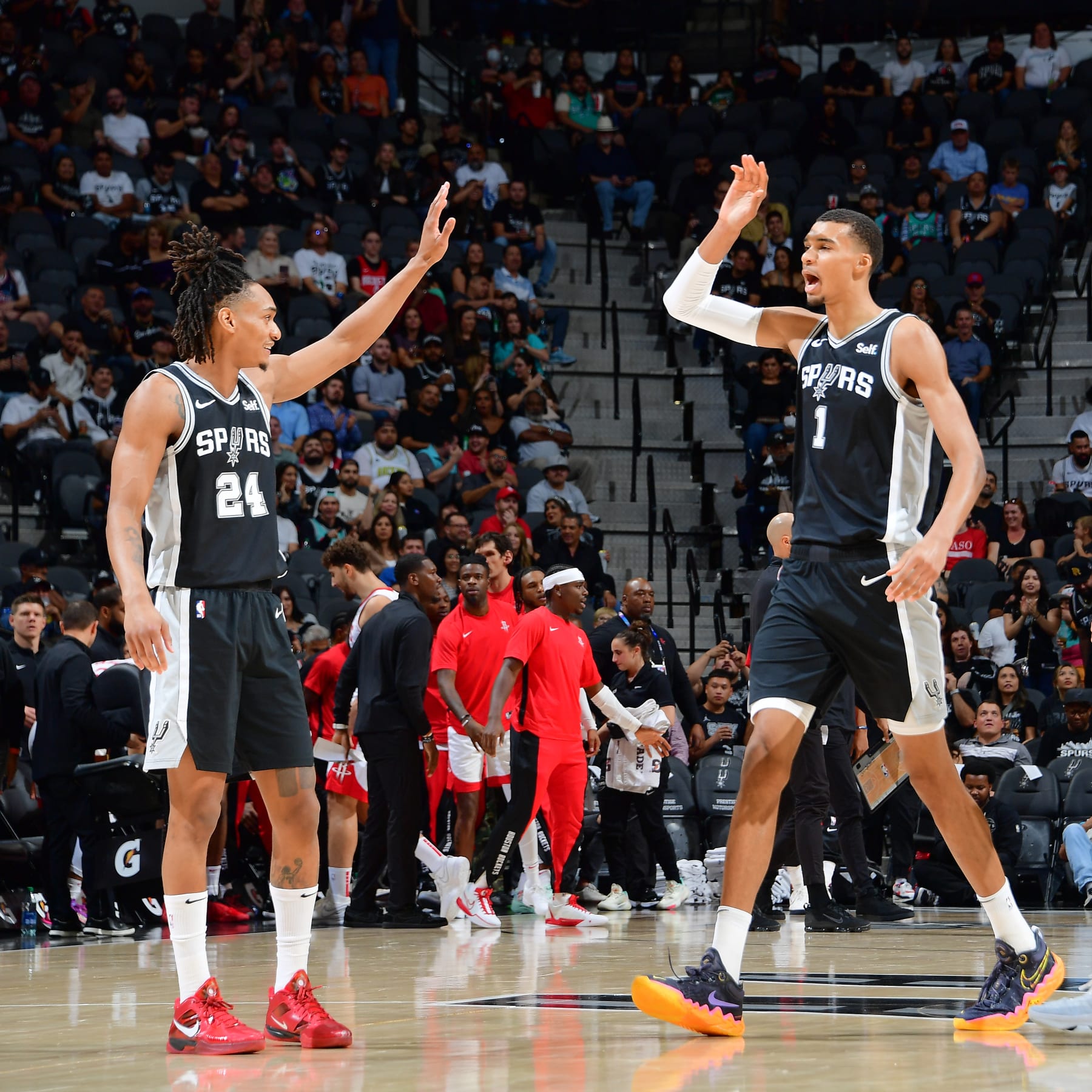 SAN ANTONIO, TX - OCTOBER 27: Devin Vassell #24 and Victor Wembanyama #1 of the San Antonio Spurs high five during the game against the Houston Rockets on October 27, 2023 at the Frost Bank Center in San Antonio, Texas. NOTE TO USER: User expressly acknowledges and agrees that, by downloading and or using this photograph, user is consenting to the terms and conditions of the Getty Images License Agreement. Mandatory Copyright Notice: Copyright 2023 NBAE (Photos by Michael Gonzales/NBAE via Getty Images)