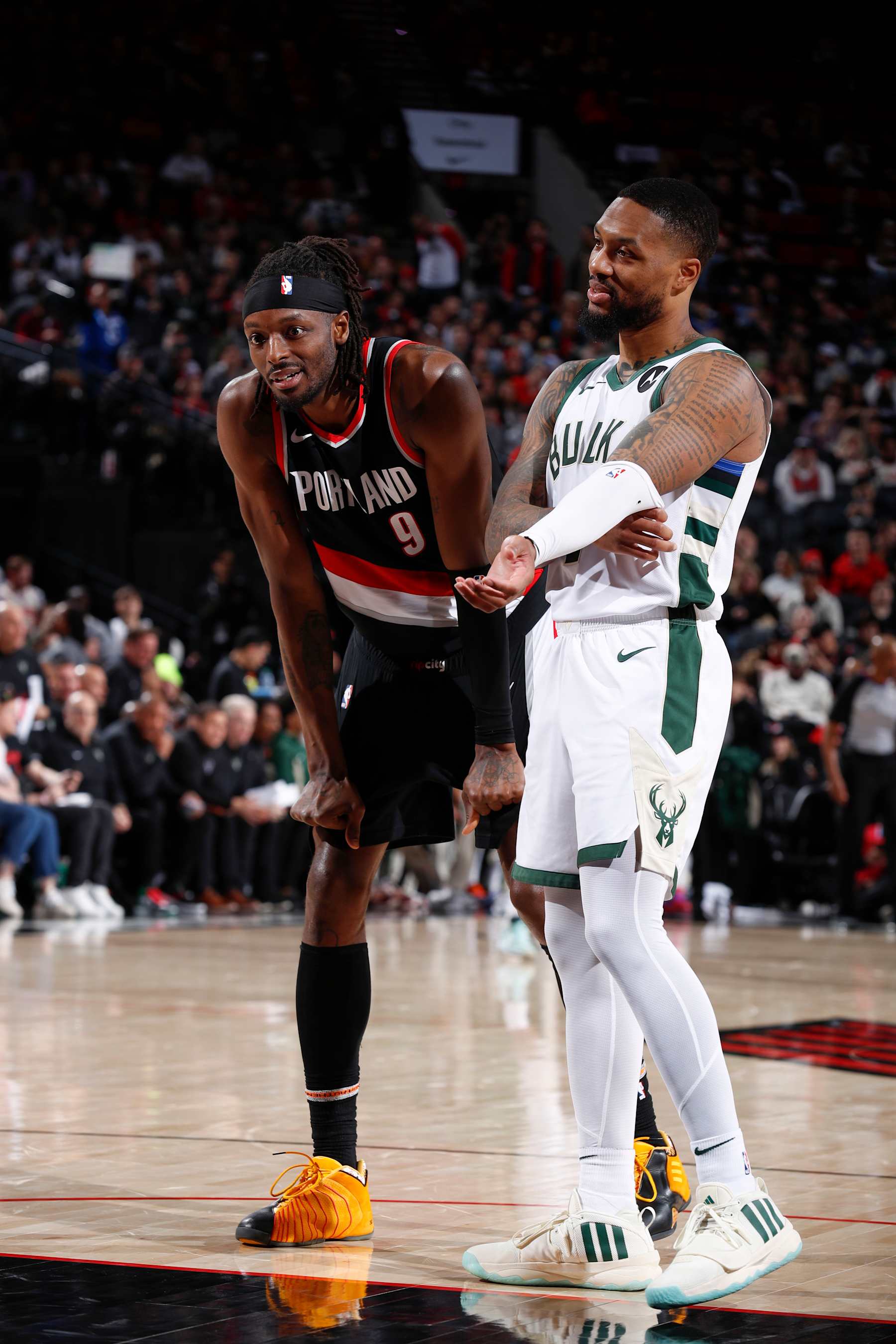 PORTLAND, OR - JANUARY 31:  Jerami Grant #9 of the Portland Trail Blazers & Damian Lillard #0 of the Milwaukee Bucks looks on during the game on January 31, 2024 at the Moda Center Arena in Portland, Oregon. NOTE TO USER: User expressly acknowledges and agrees that, by downloading and or using this photograph, user is consenting to the terms and conditions of the Getty Images License Agreement. Mandatory Copyright Notice: Copyright 2024 NBAE (Photo by Cameron Browne/NBAE via Getty Images)