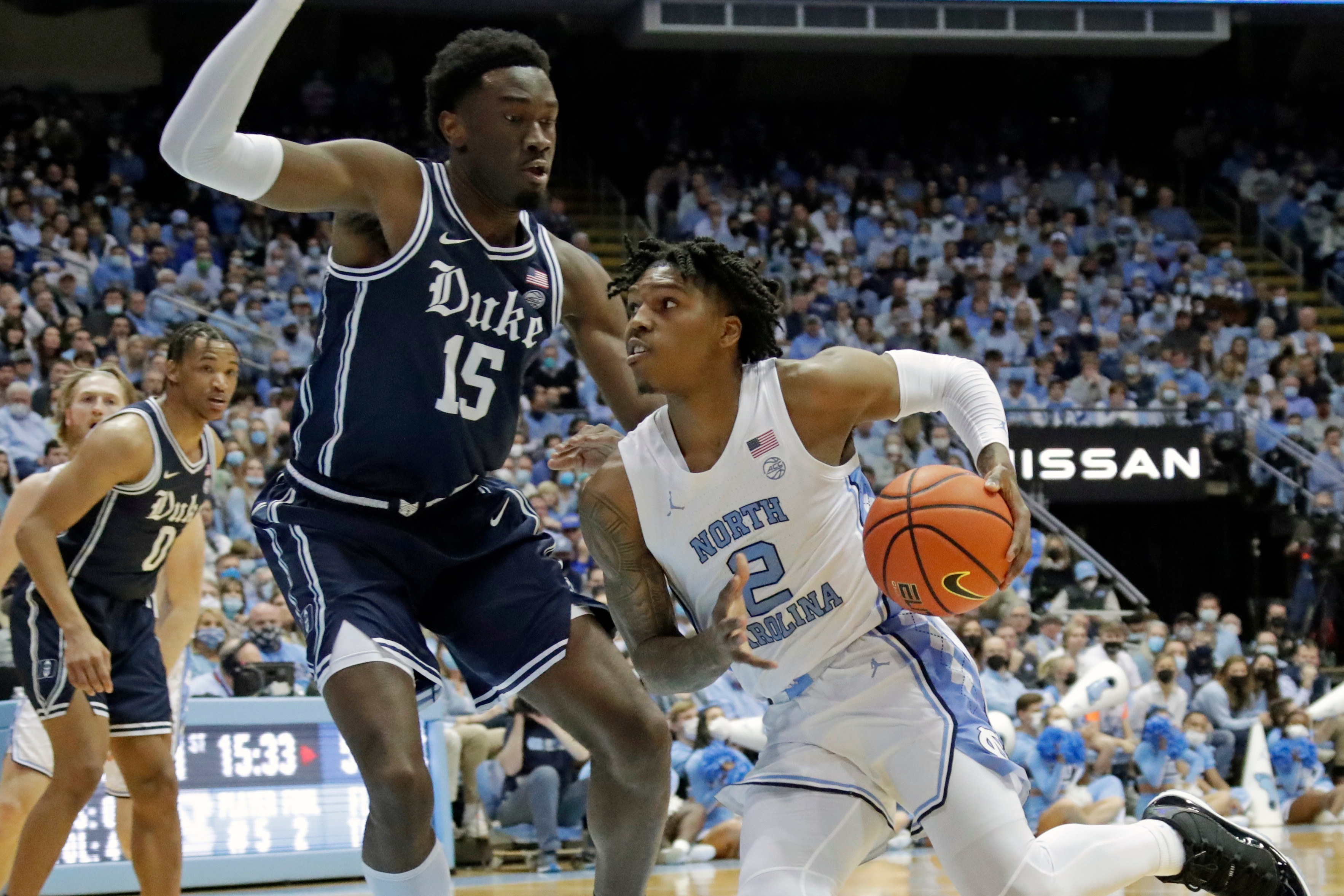 North Carolina guard Caleb Love (2) drives against Duke center Mark Williams (15) during the first half of an NCAA college basketball game, Saturday, Feb. 5, 2022, in Chapel Hill, N.C. (AP Photo/Chris Seward)