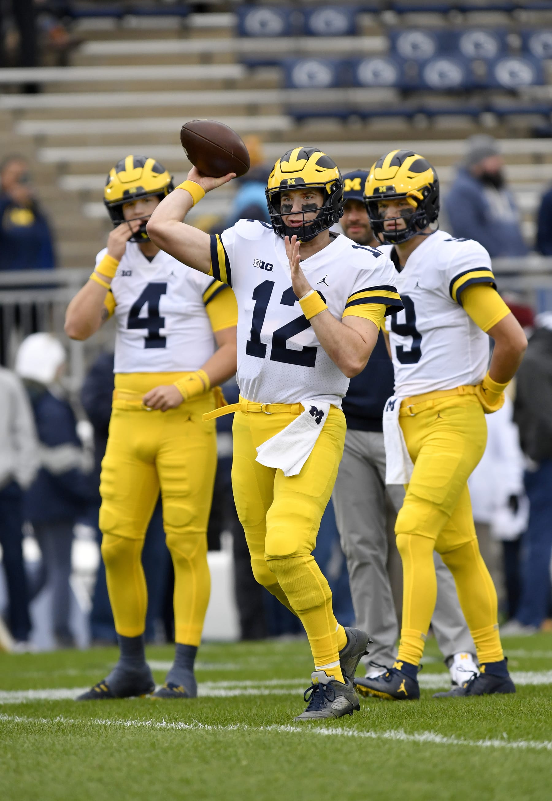 UNIVERSITY PARK, PA - NOVEMBER 13: Michigan quarterback Cade McNamara (12) throws while Dan Villari (4) and J.J. McCarthy (9) watch during the Michigan Wolverines versus Penn State Nittany Lions game on November 13, 2021 at Beaver Stadium in University Park, PA. (Photo by Randy Litzinger/Icon Sportswire via Getty Images)