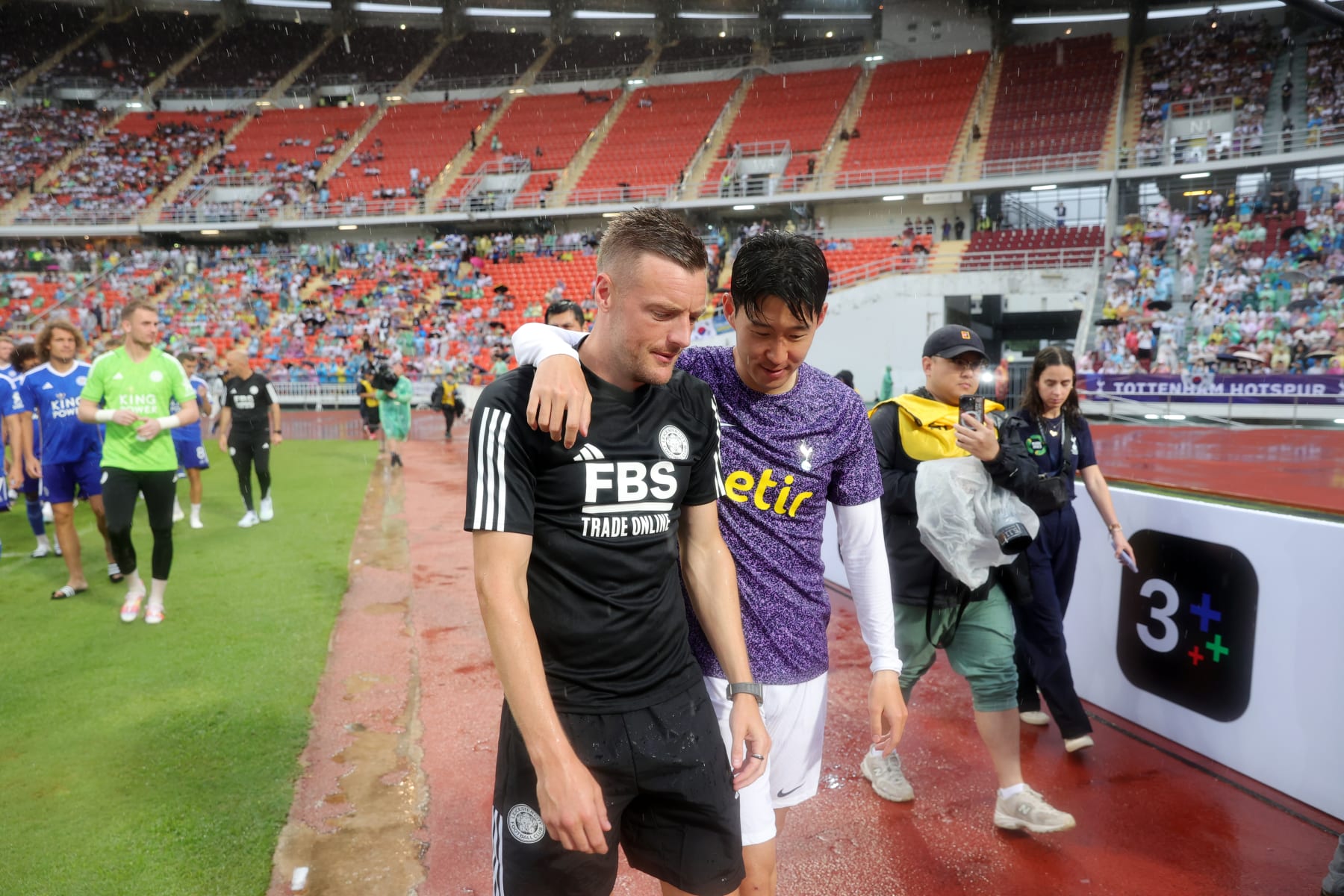 BANGKOK, THAILAND - JULY 23: Jamie Vardy of Leicester City and Son Heung-Min of Tottenham Hotspur during a lap of the pitch to thank fans and mascots for their support after the pre-season friendly match between Tottenham Hotspur and Leicester City at Rajamangala Stadium was cancelled on July 23, 2023 in Bangkok, Thailand. The match was cancelled due to weather conditions. (Photo by Plumb Images/Leicester City FC via Getty Images)